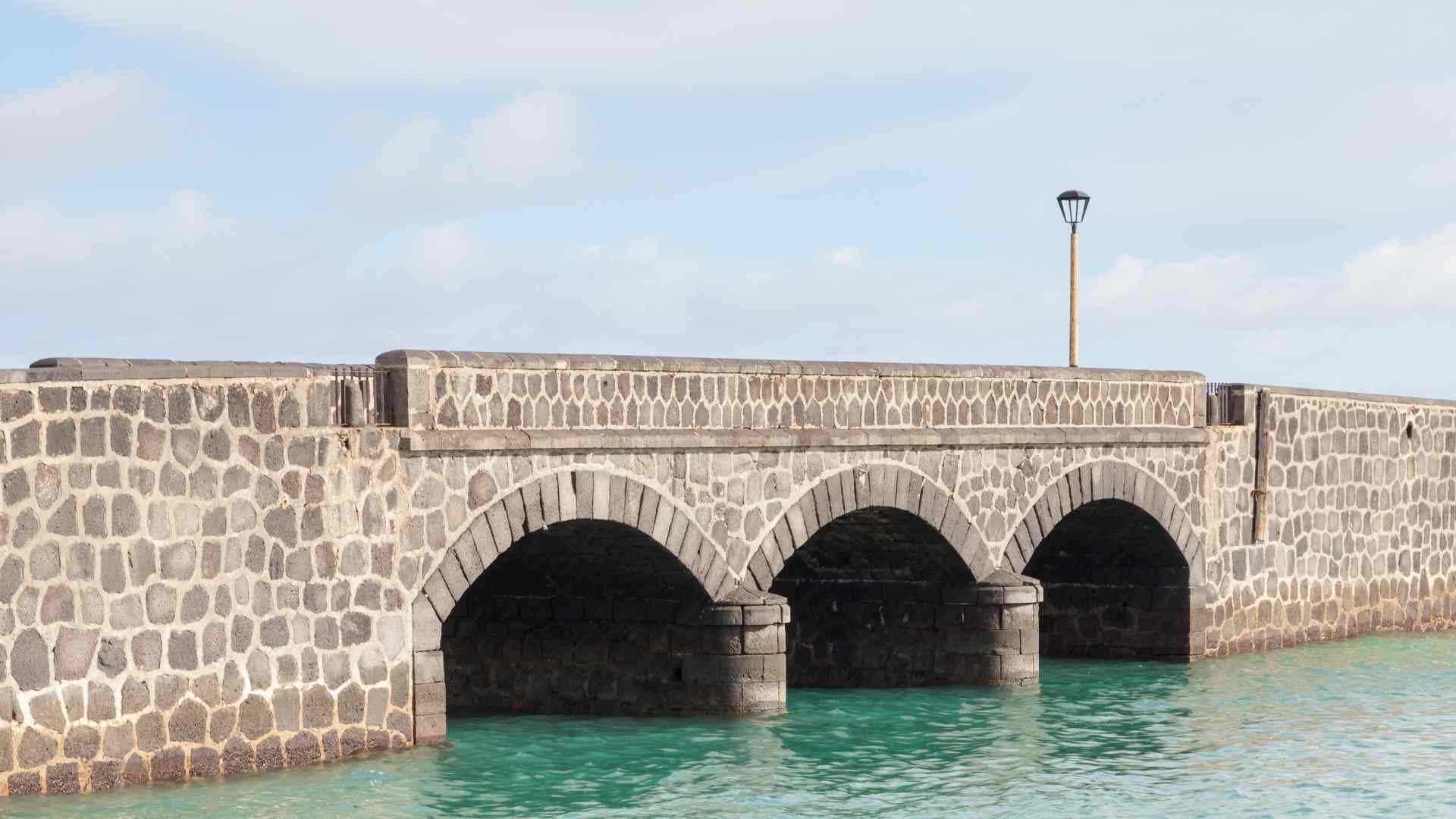 Stone bridge leading toward Arrecife's harbor fortress