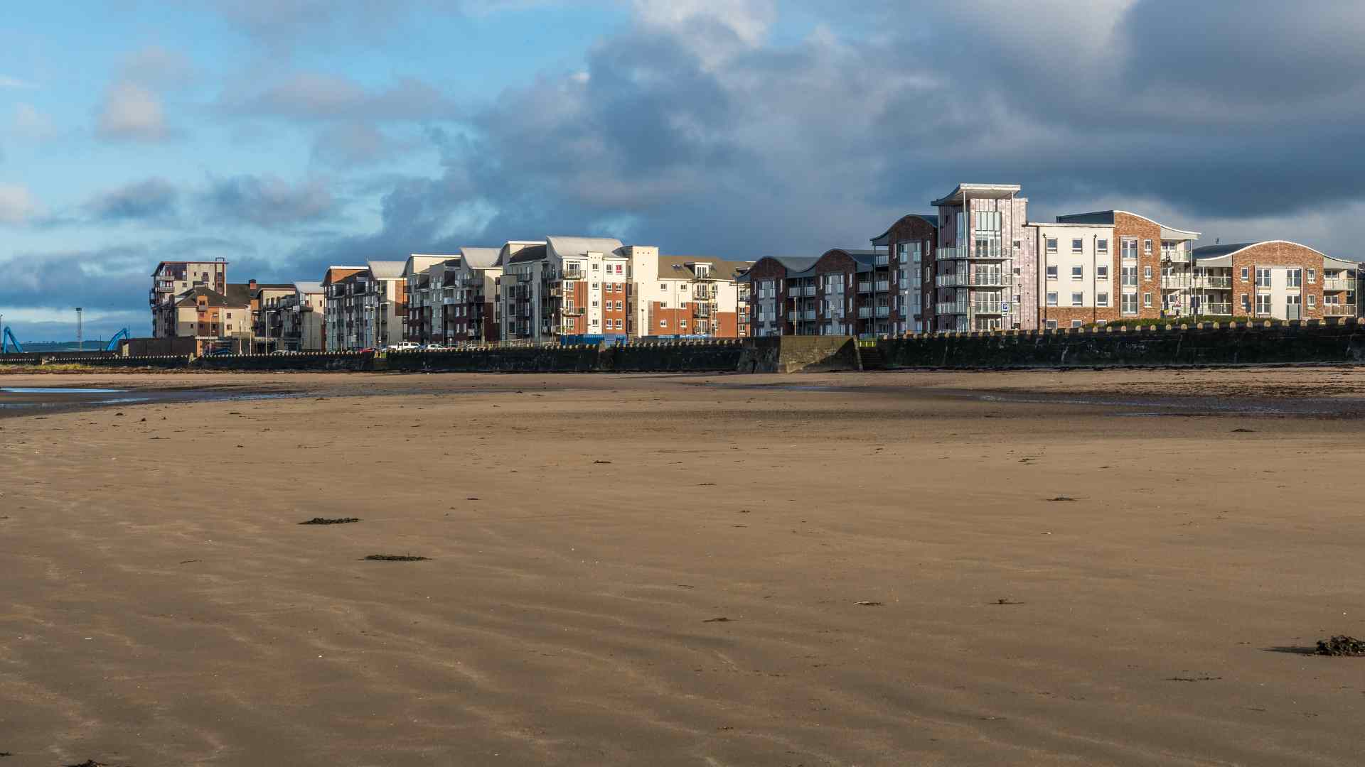 Waterfront apartments and sandy riverbank in Ayr