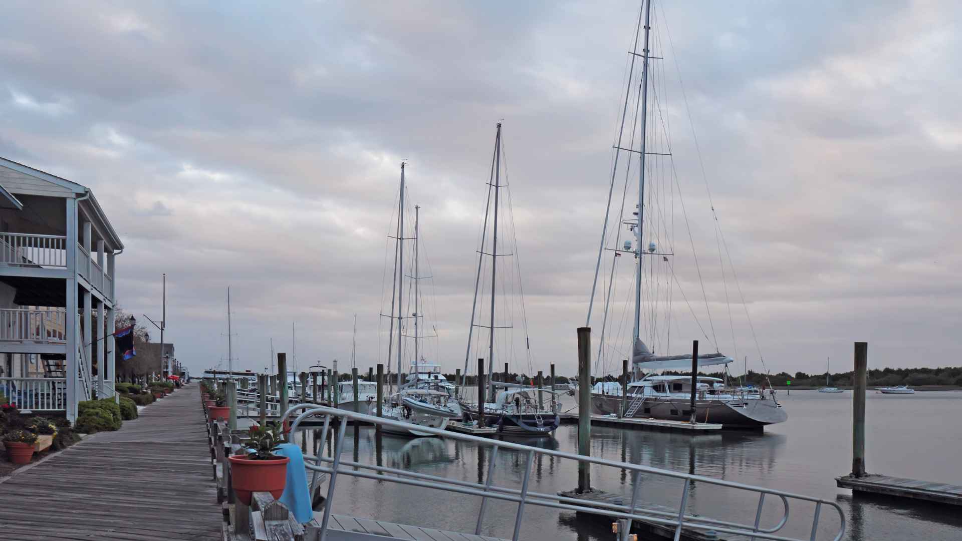 Dock with sailboats at dusk