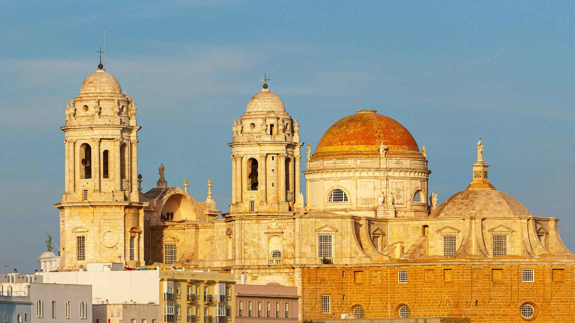 Golden facade and domes of Cadiz Cathedral, Spain