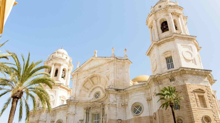 Cadiz Cathedral dome framed by palm trees