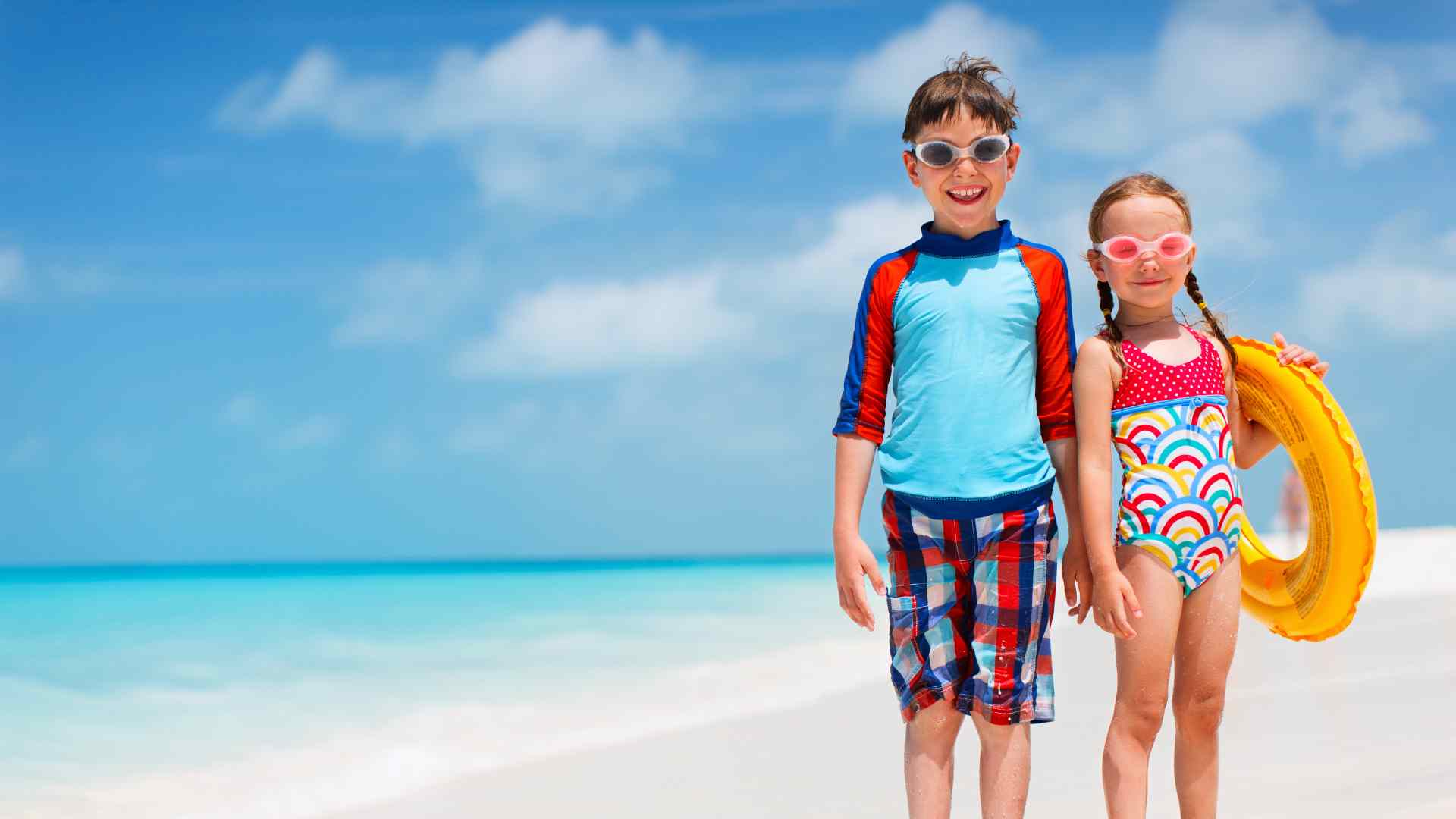 Children carrying a pool float on Castaway Cay beach