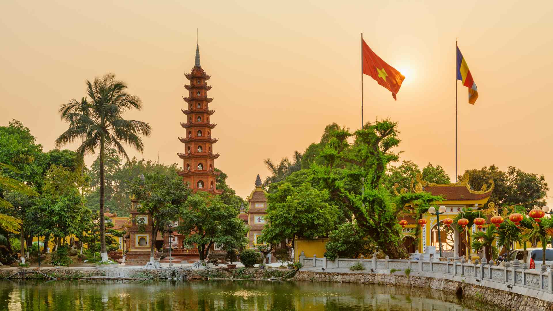 Tran Quoc Pagoda and Vietnamese flags in Hanoi