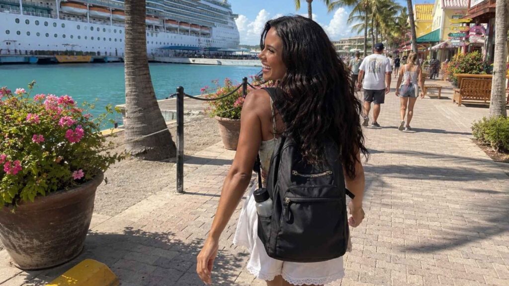 Ellie Simons walking with her bag in port