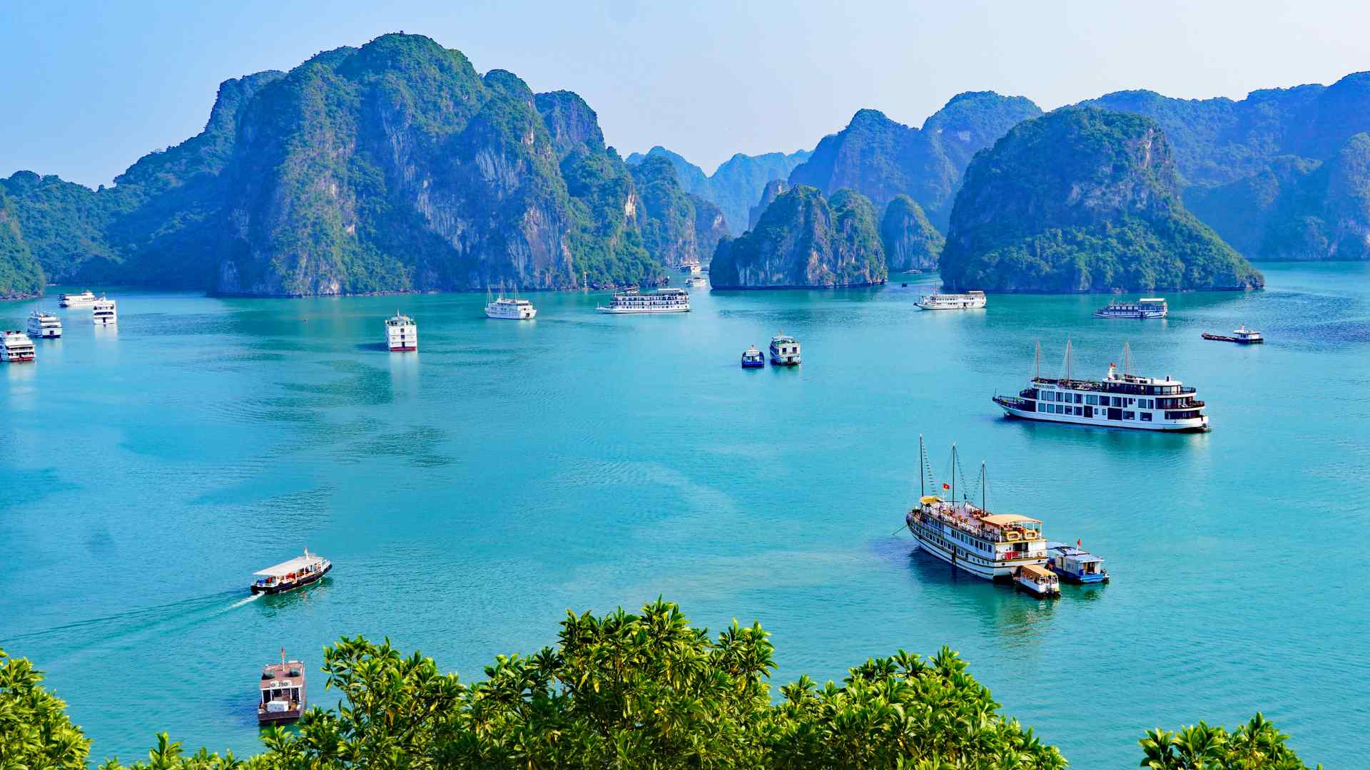 Tour boats cruising among Ha Long Bay's limestone karsts