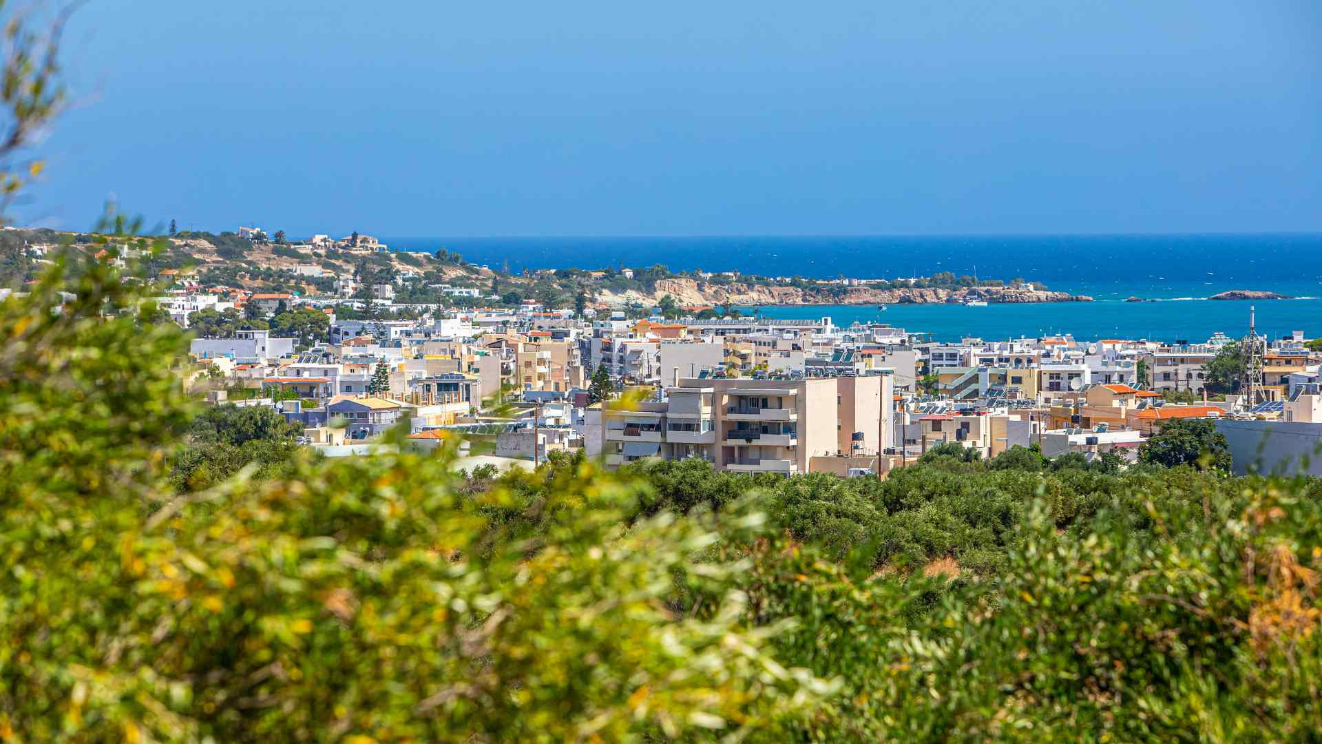 Heraklion city and coastline viewed from a green hillside