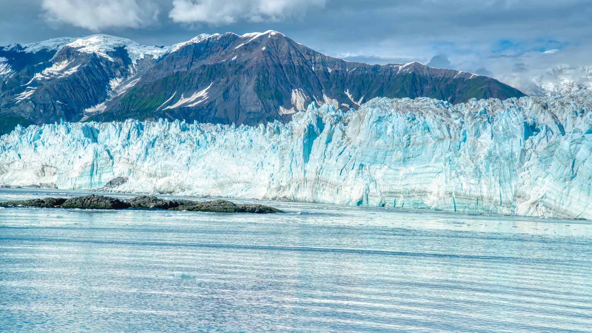 Hubbard Glacier front with snow-covered mountains beyond
