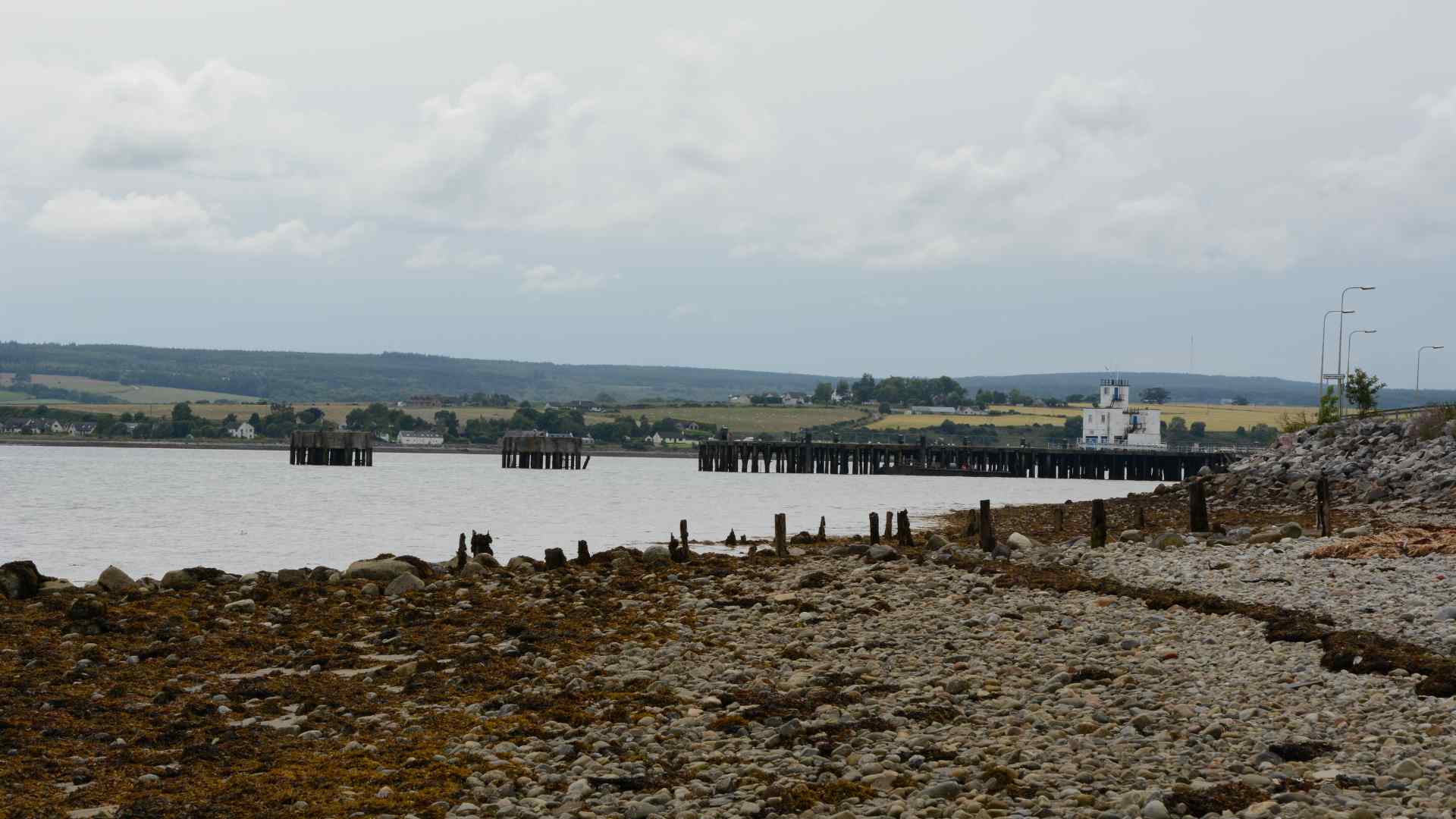Rocky shore and old pier along the Cromarty Firth