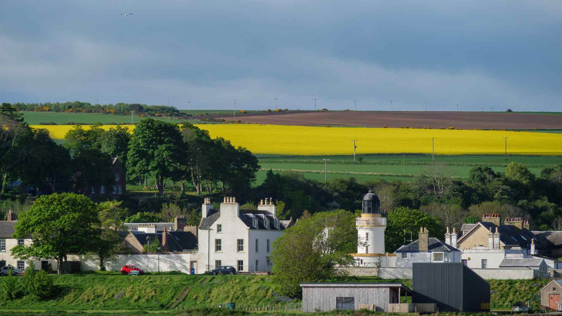 White church and lighthouse in the countryside near Invergordon