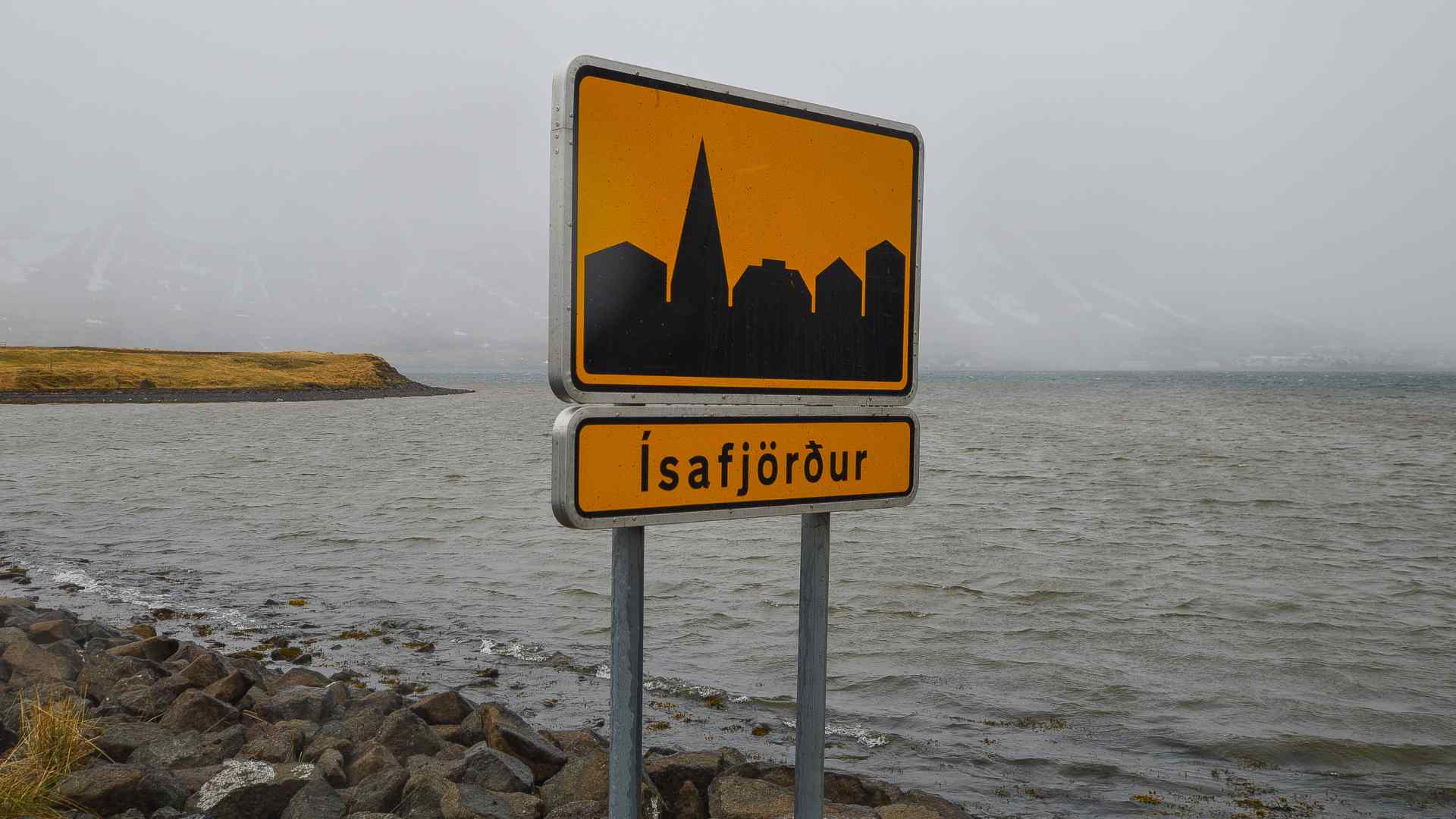 Isafjordur roadside sign beside the Icelandic fjord