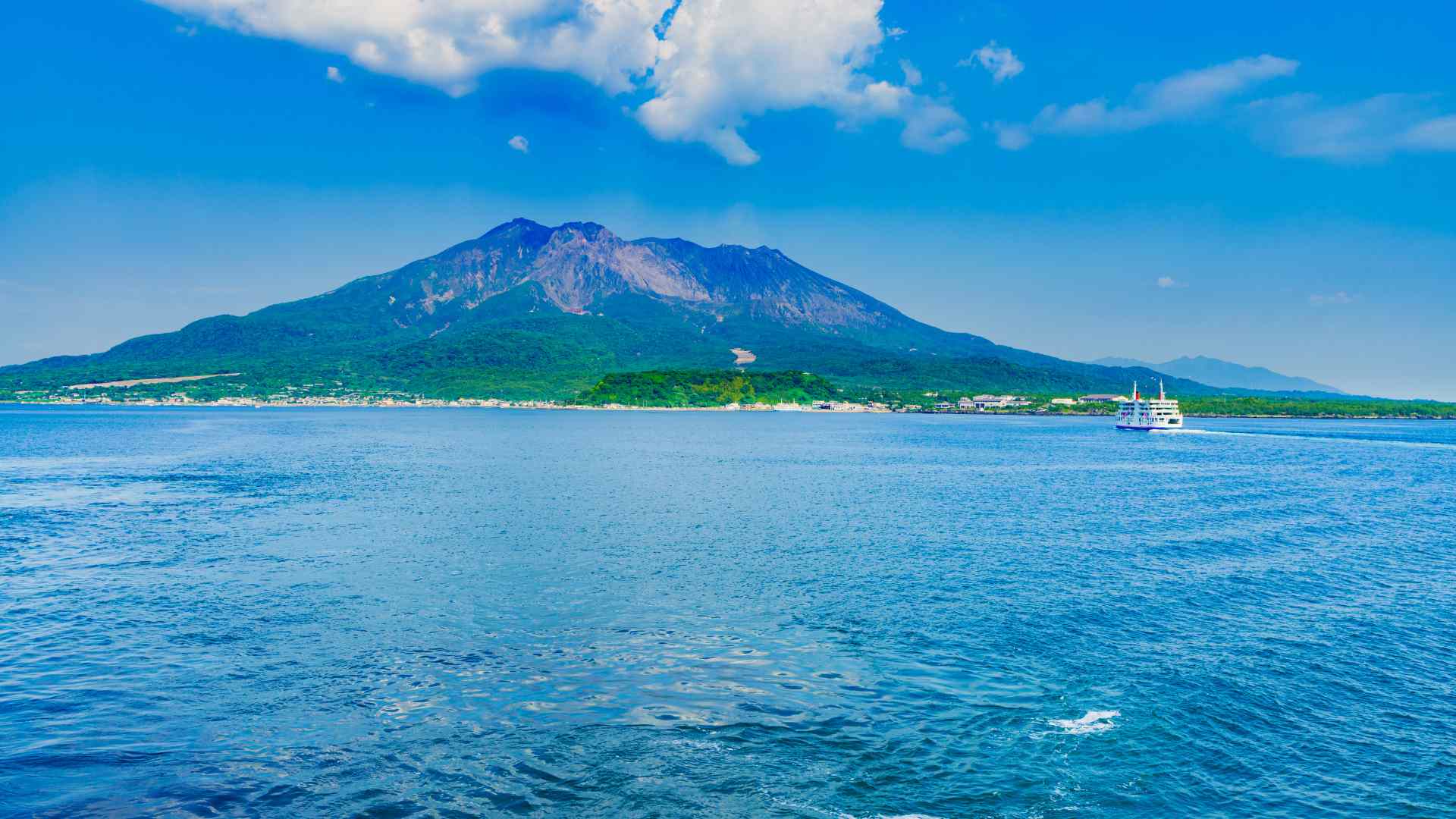 Sakurajima volcano across the blue waters of Kagoshima Bay