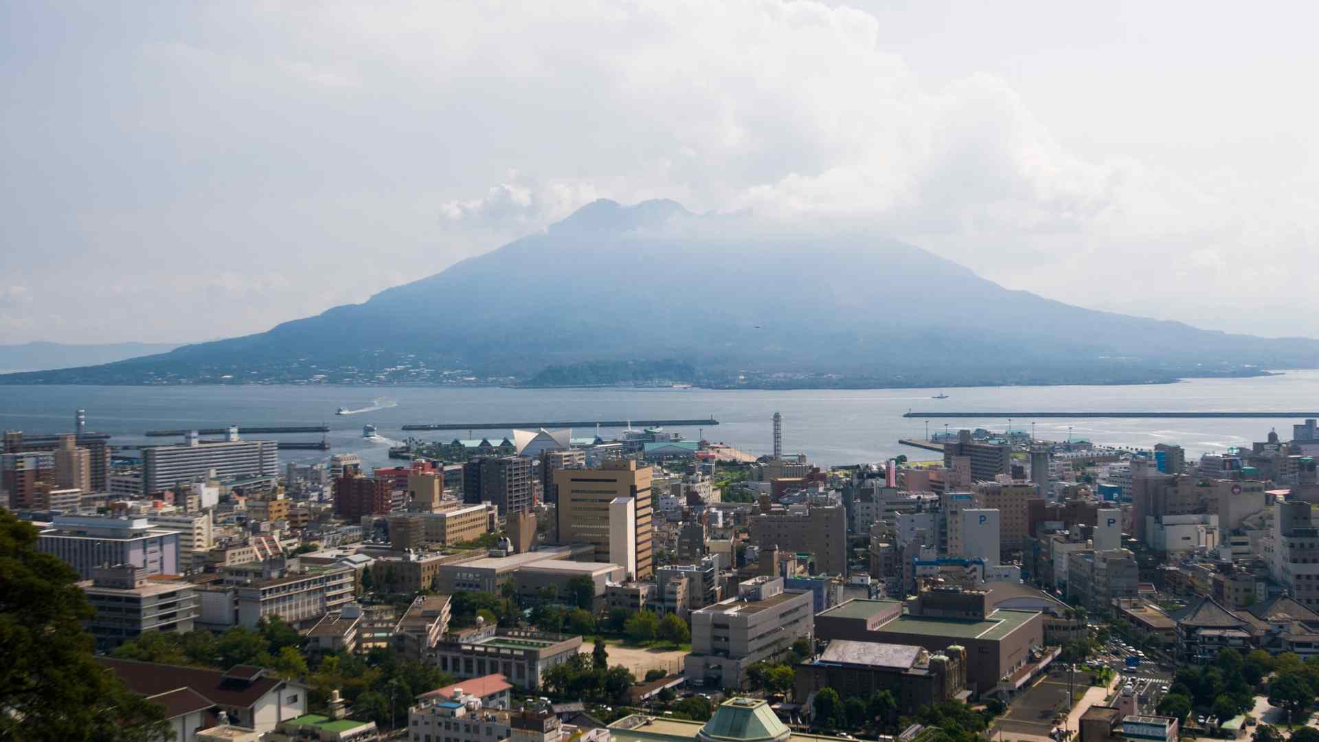 Kagoshima city and harbor beneath Sakurajima volcano