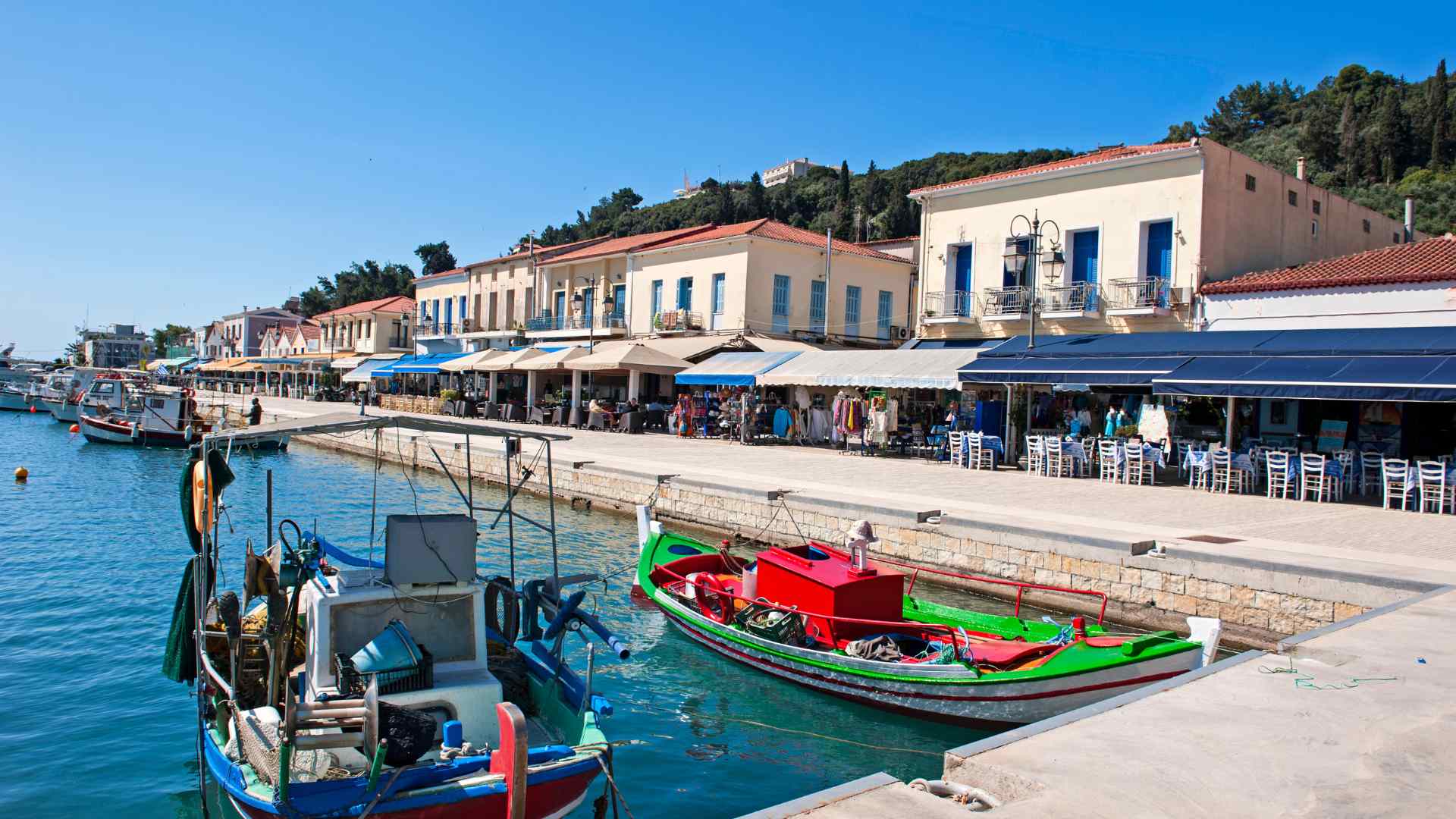 Katakolon harbor promenade with colorful fishing boats