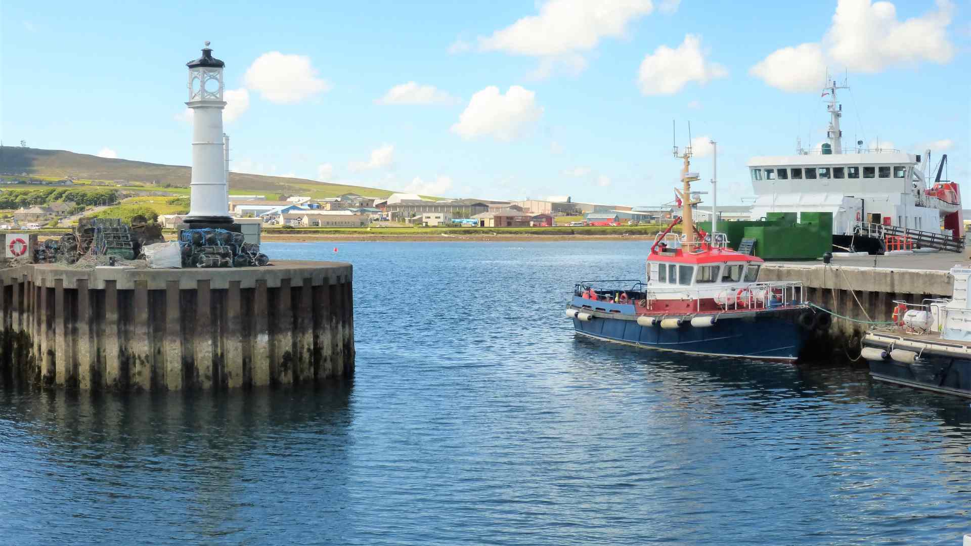 Ferry arriving beside the lighthouse at Kirkwall harbor