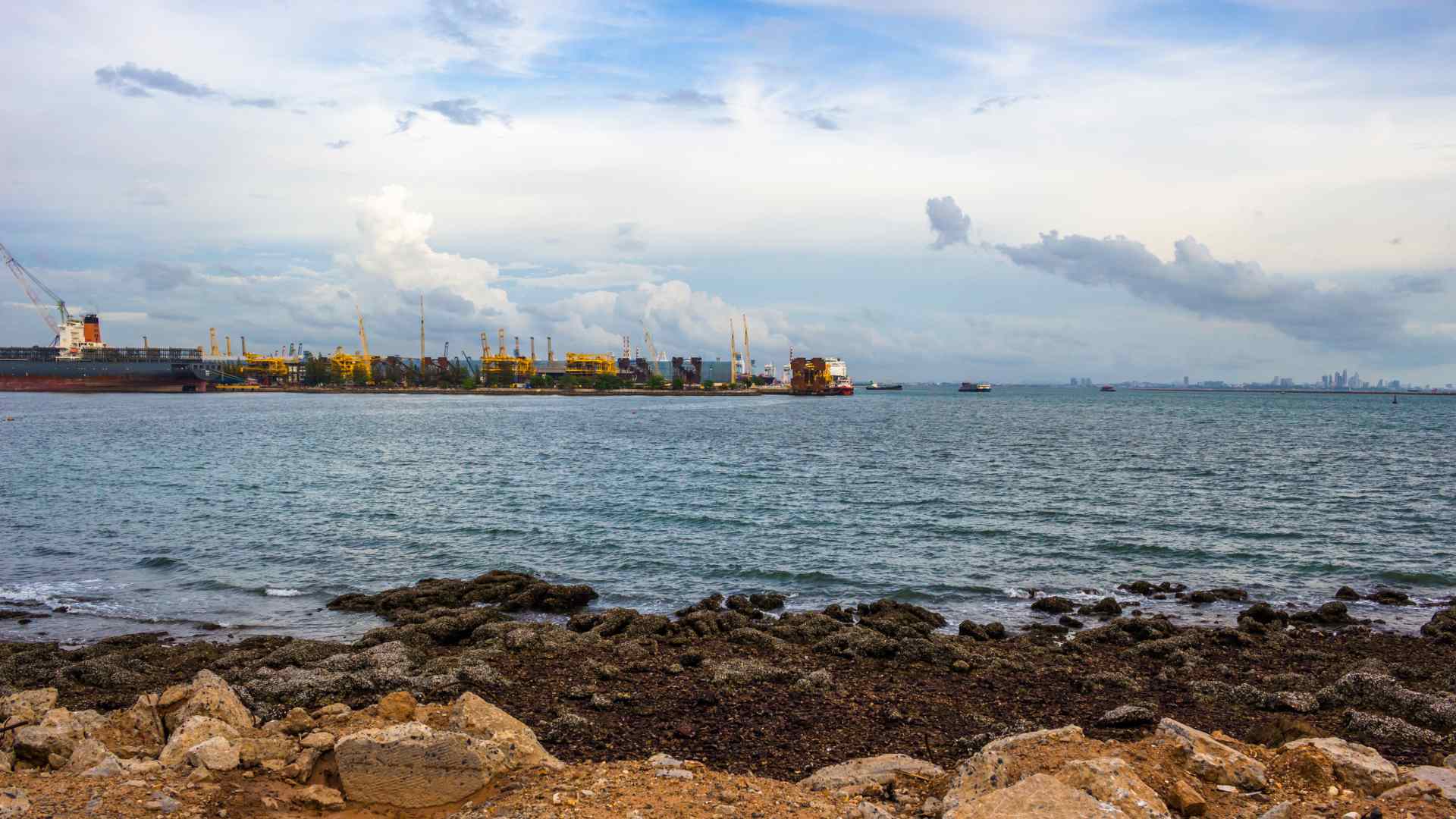 Industrial port across the rocky shoreline at Laem Chabang