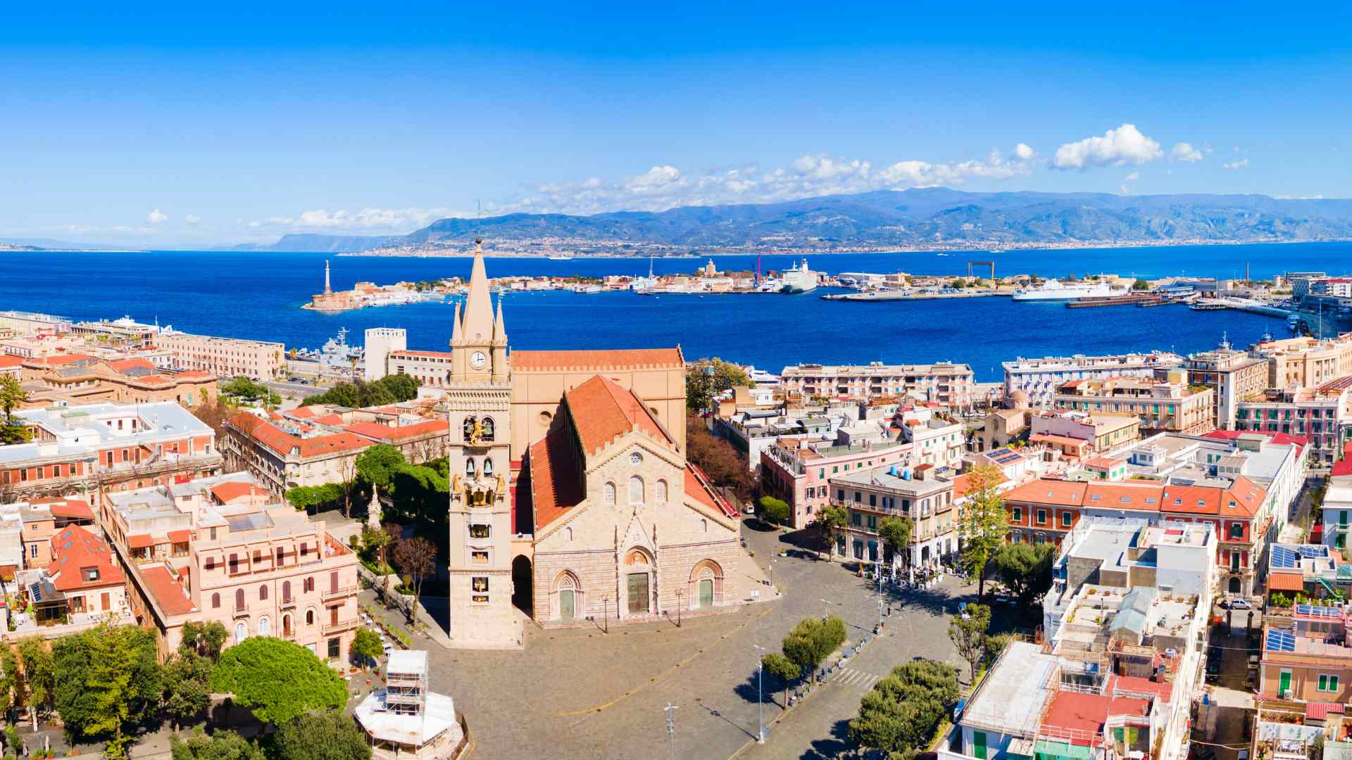 Messina waterfront rooftops, church and harbor on Sicily
