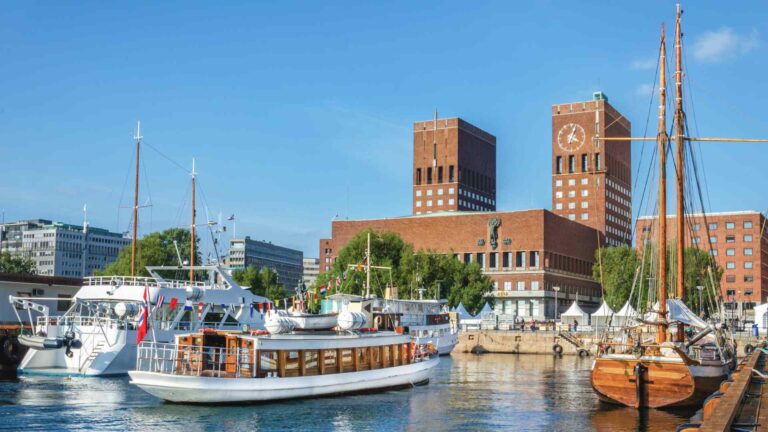 Oslo harbor with boats and City Hall towers