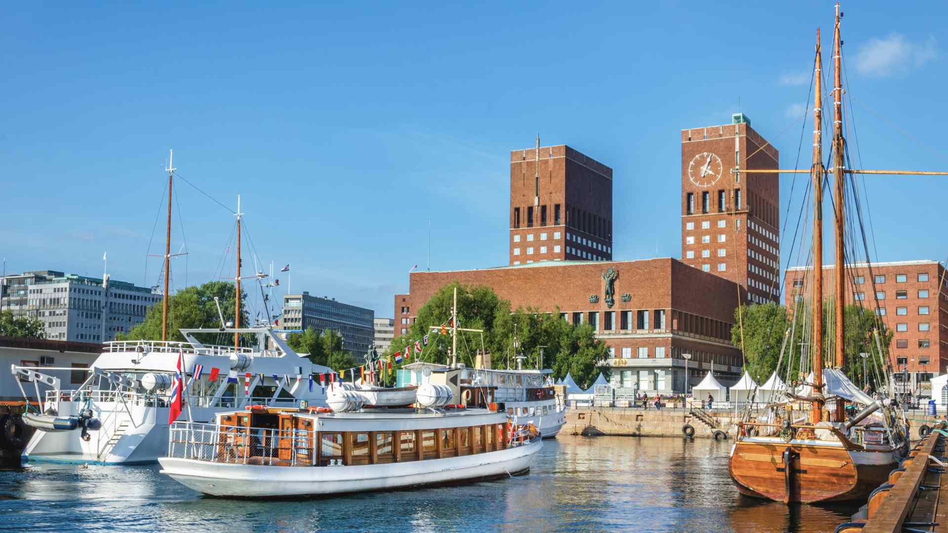 Oslo harbor with boats and City Hall towers