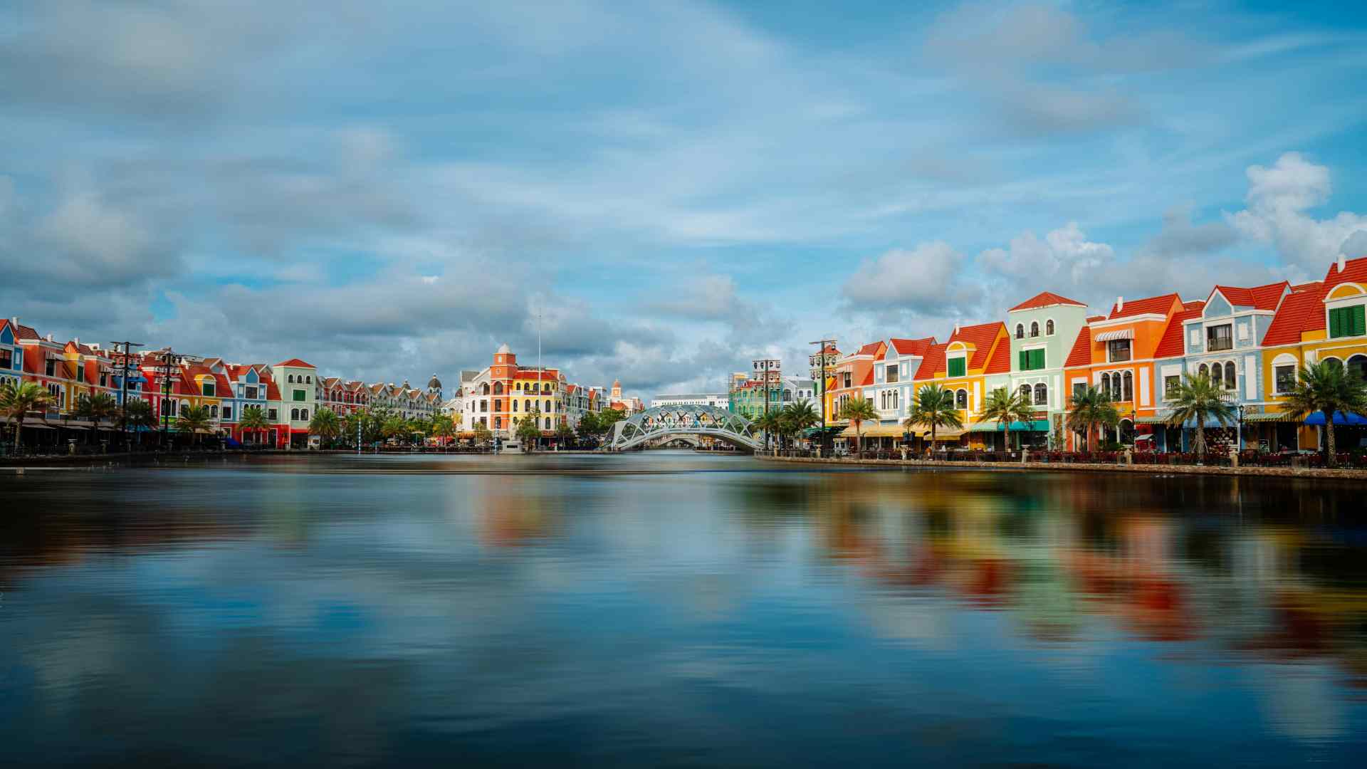 Colorful canal-side buildings in a Vietnamese waterfront district