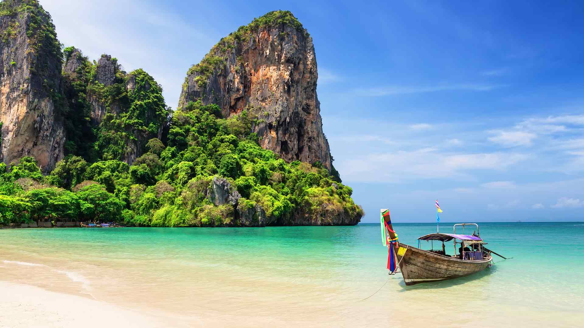 Long-tail boat at a limestone beach near Phuket