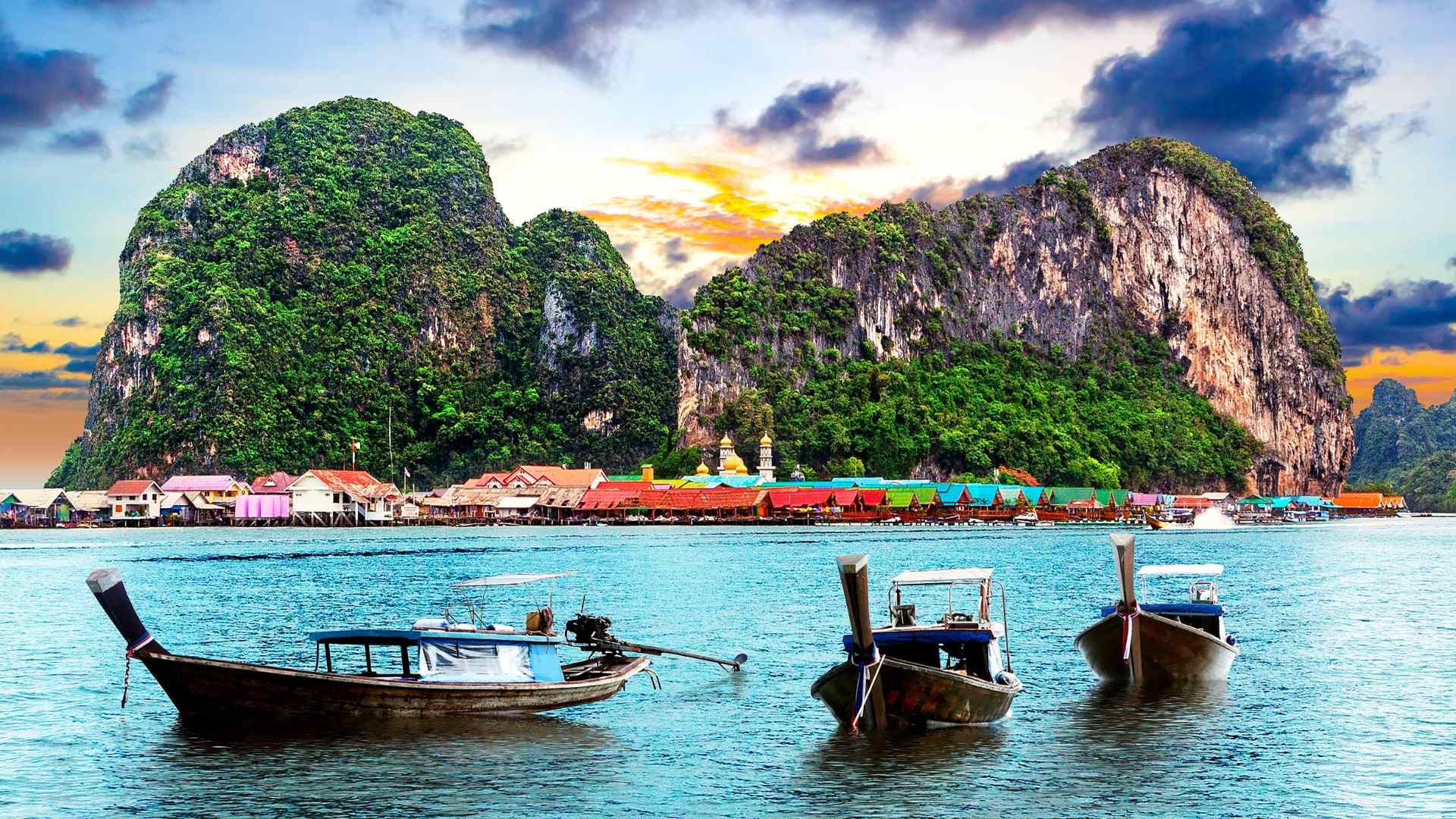 Long-tail boats anchored beside a tropical island near Phuket