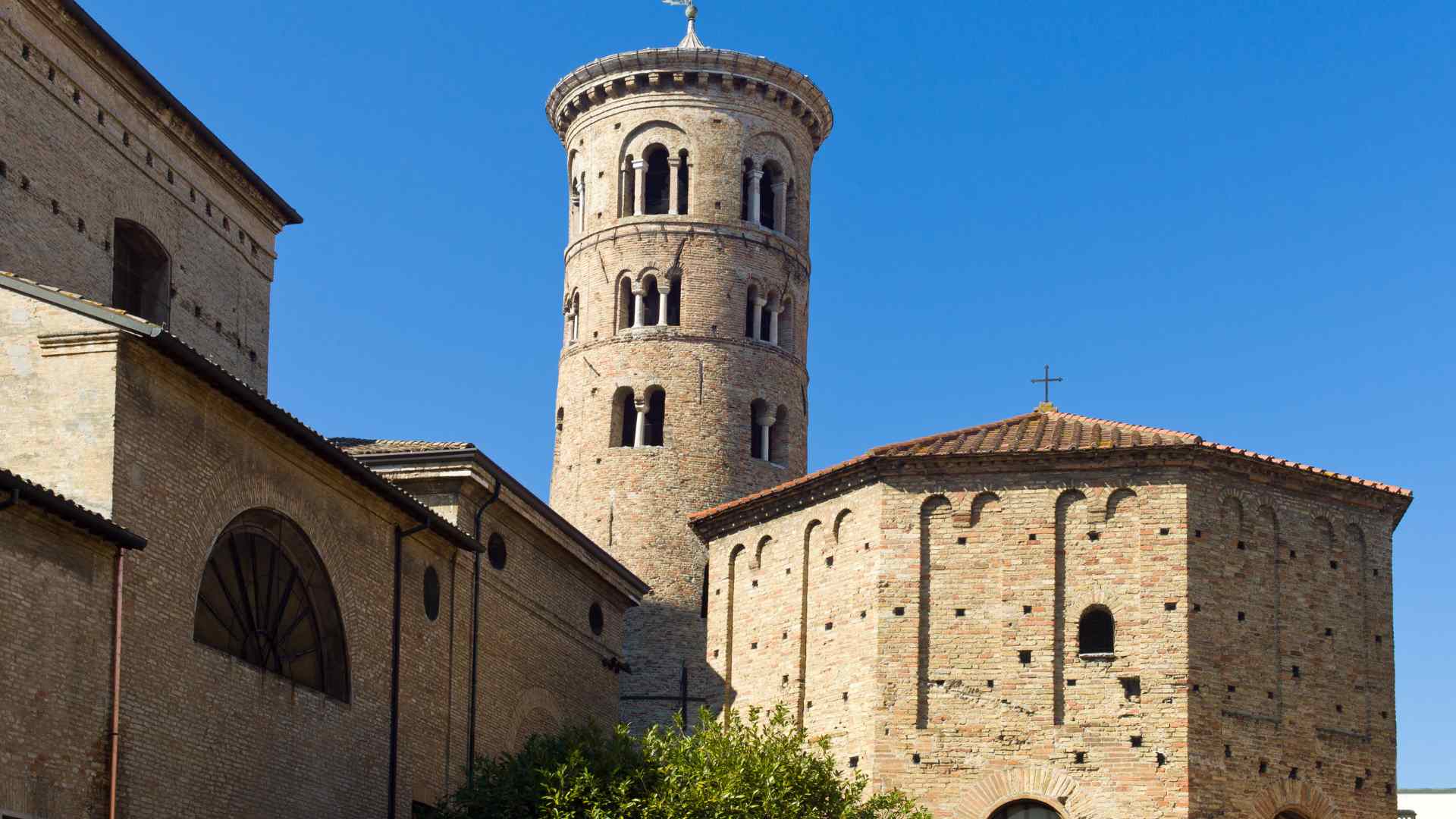 Round bell tower and ancient basilica in Ravenna, Italy