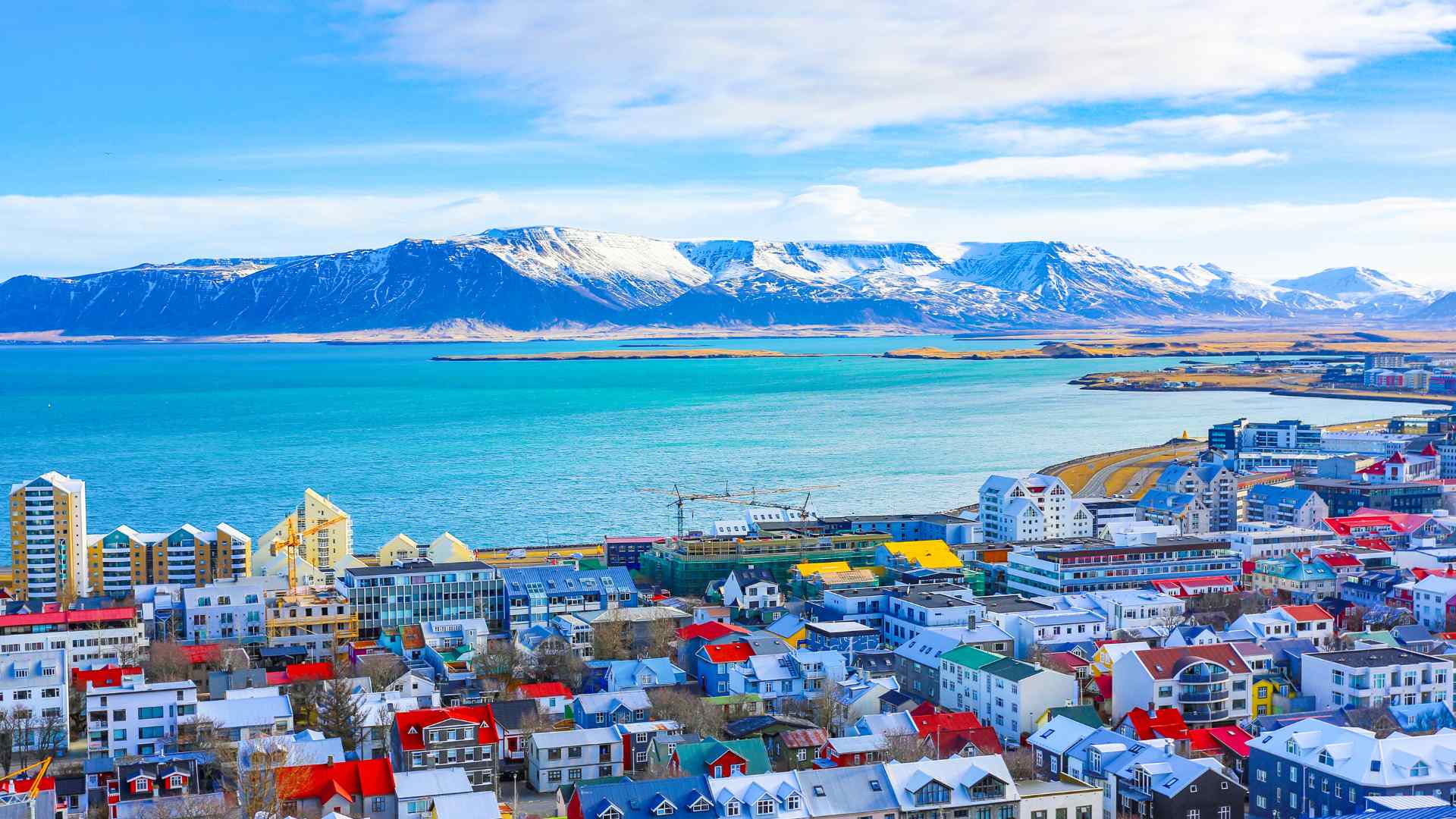 Colorful Reykjavik waterfront with mountains across the bay