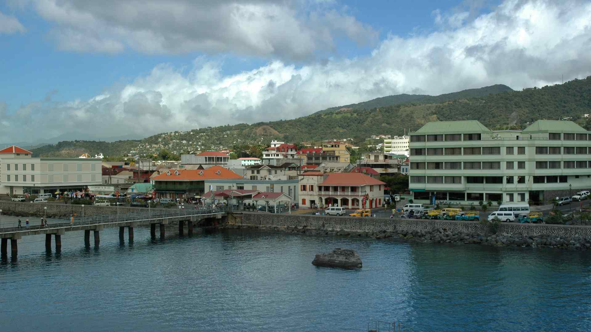 Roseau cruise pier and waterfront beneath cloudy mountains