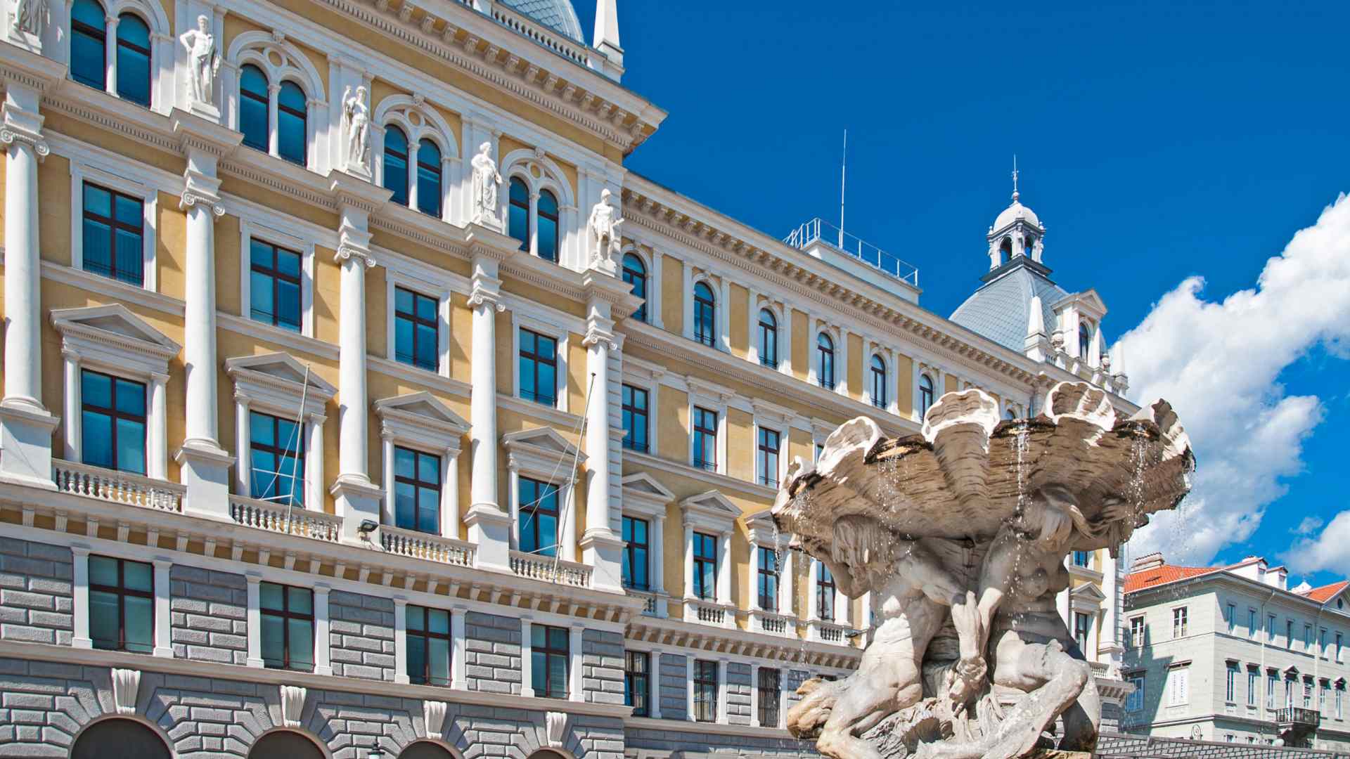 Historic fountain and ornate buildings in central Trieste