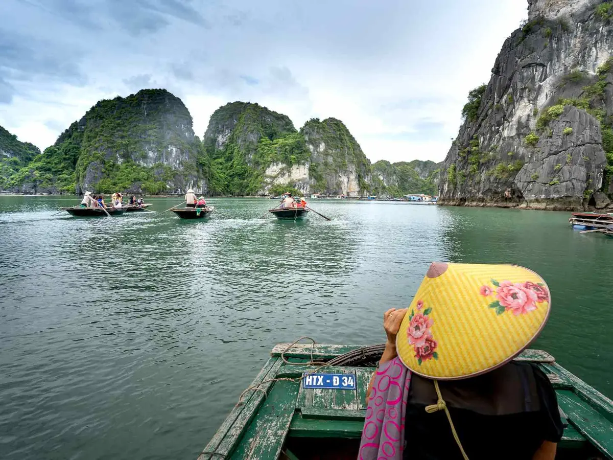 Traveler boating through Ha Long Bay in Vietnam