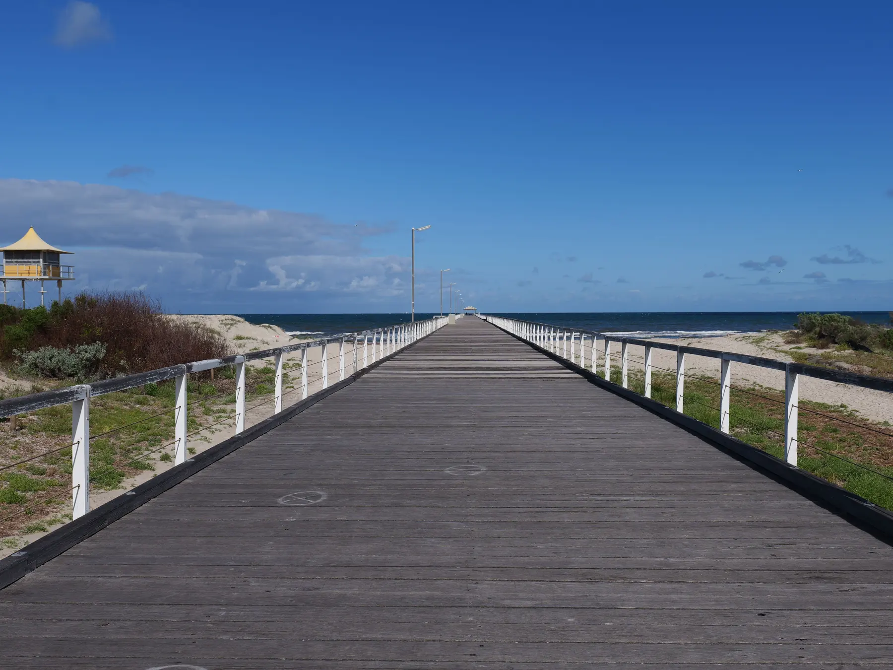 Port Noarlunga jetty reaching into the calm sea near Adelaide, South Australia.