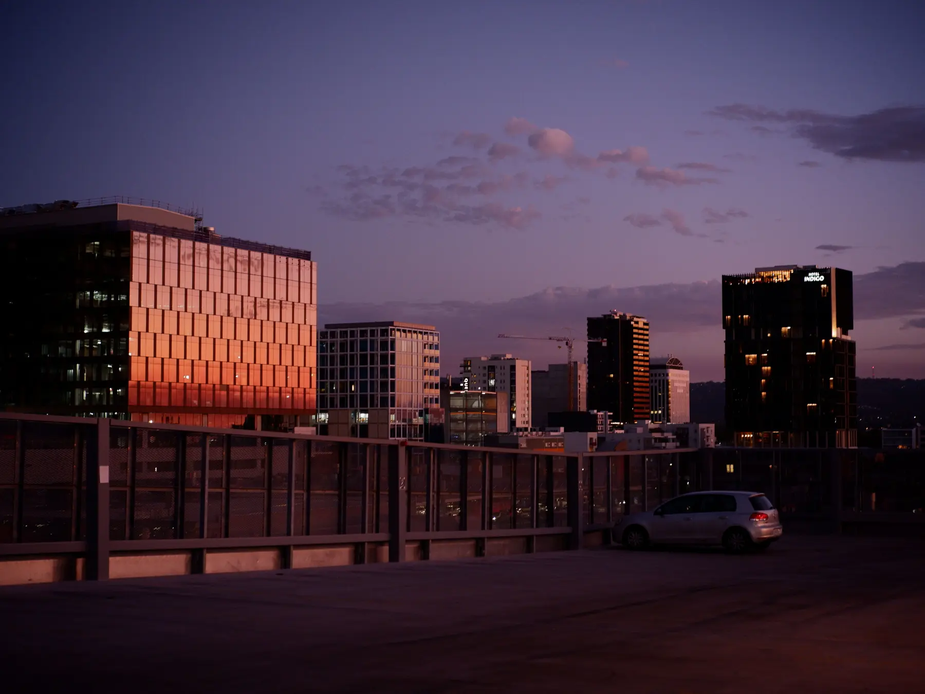 Adelaide skyline and modern city buildings under a colorful twilight sky.