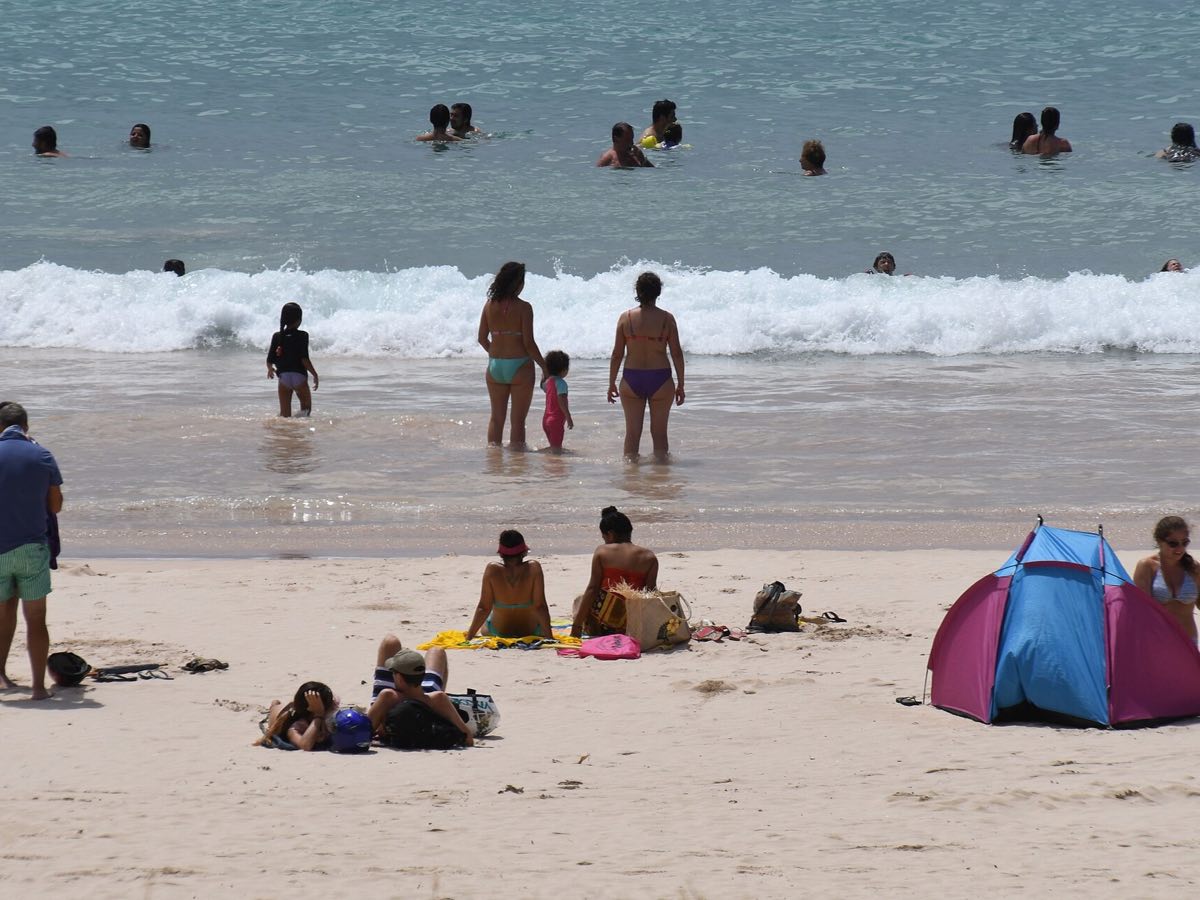 Visitors swimming at Anakena Beach on Easter Island