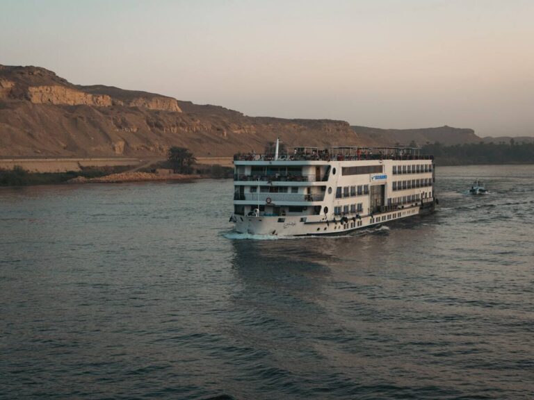 Nile cruise ship sailing past the desert hills near Aswan, Egypt