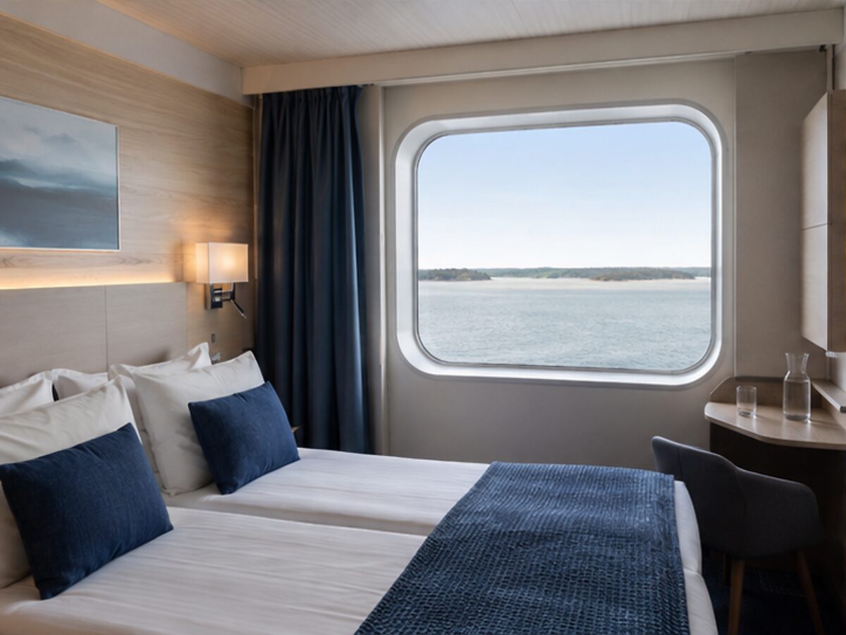 Modern overnight ferry cabin with a large window overlooking the Baltic Sea