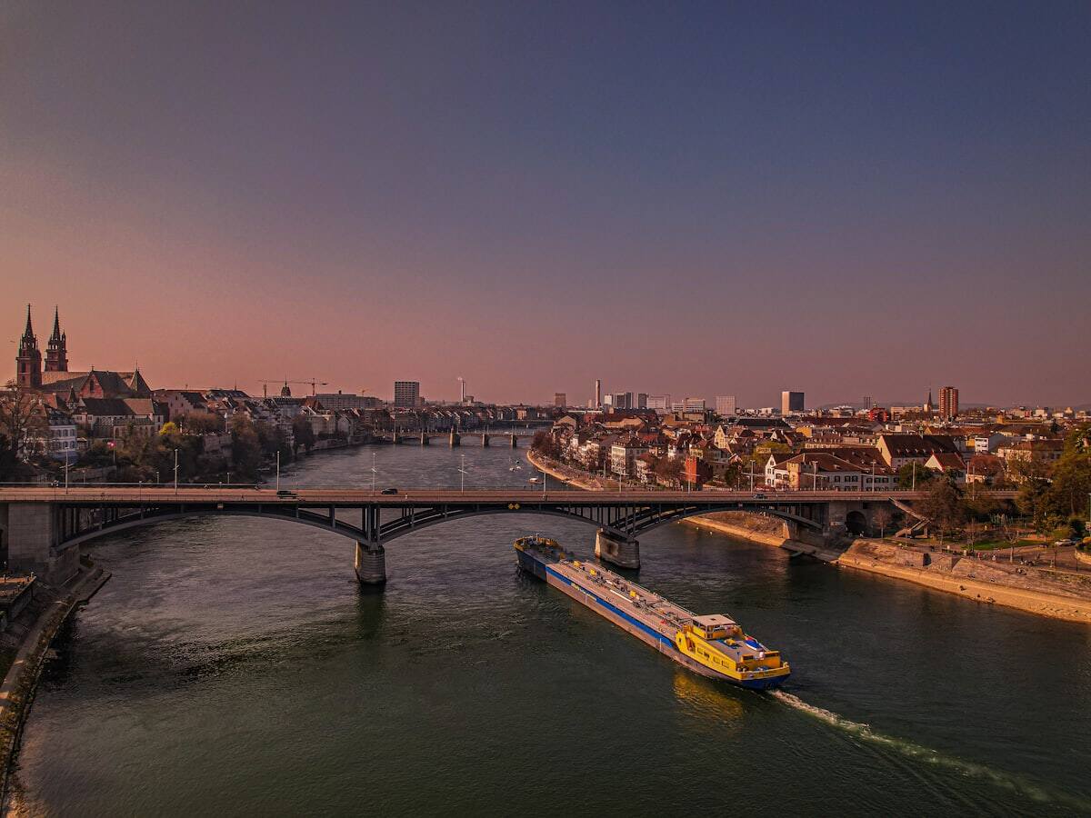 Riverboat sailing through Basel on the Rhine at sunset