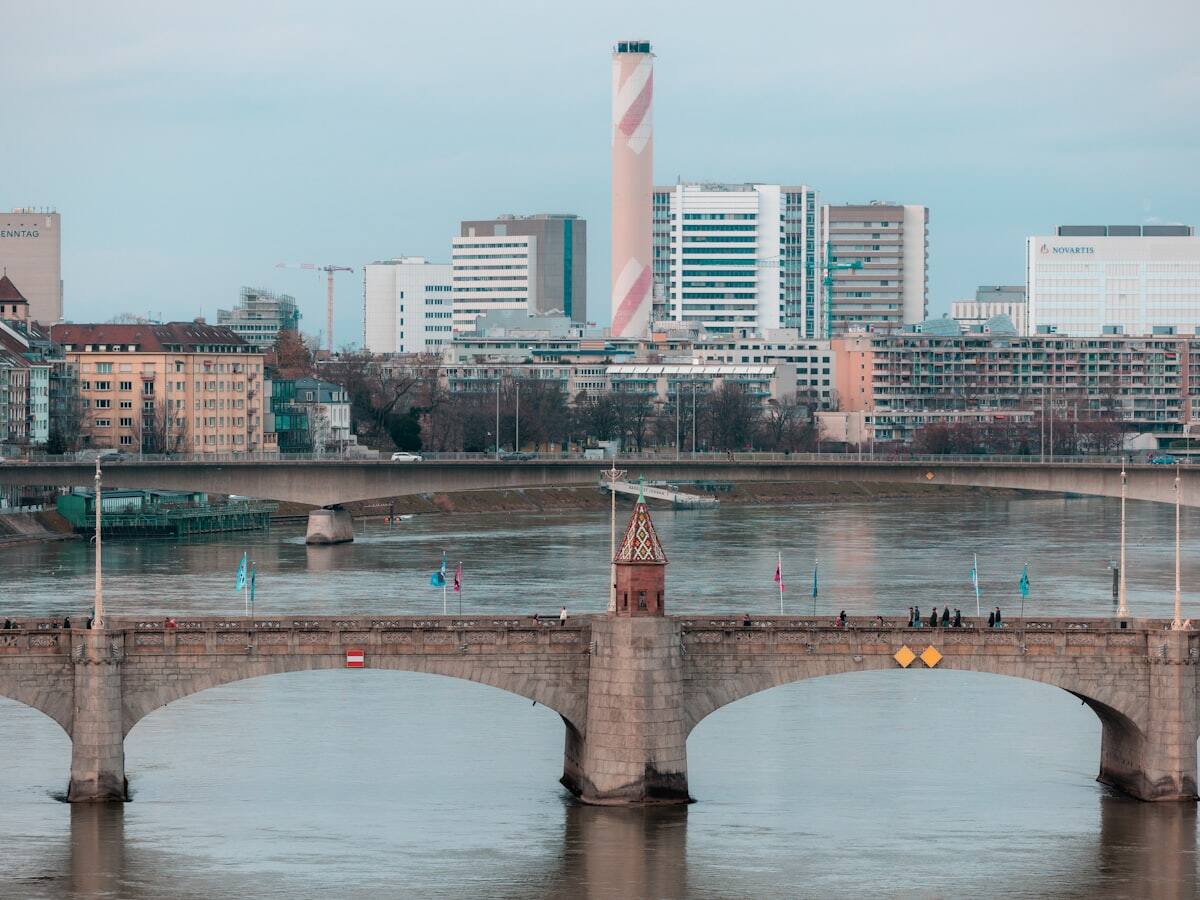 Historic bridge across the Rhine with Basel's city skyline beyond