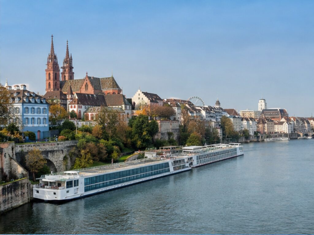 Long river cruise ship berthed on the Rhine beside Basel's historic skyline
