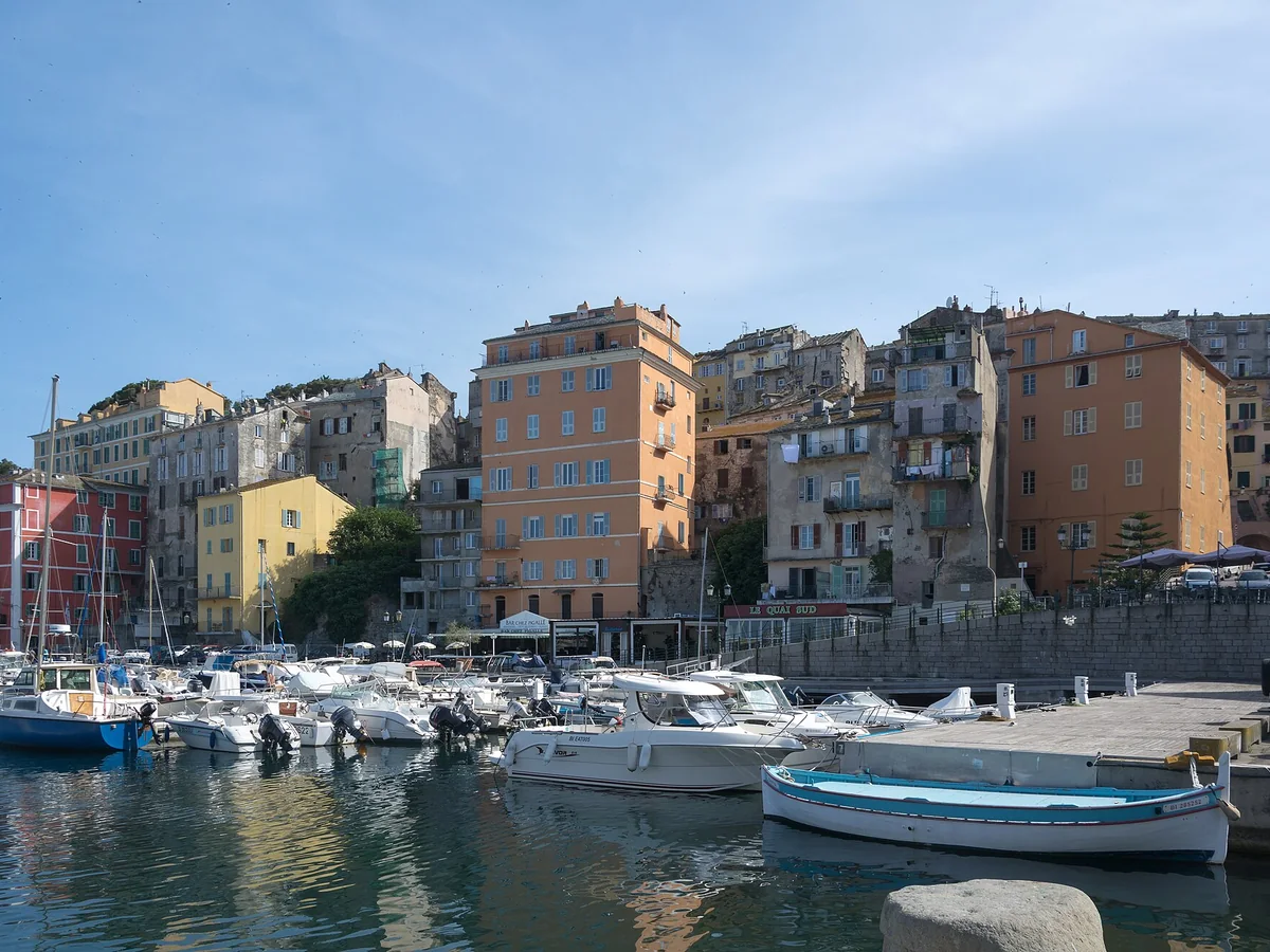 Boats and colorful waterfront buildings in Bastia Old Port