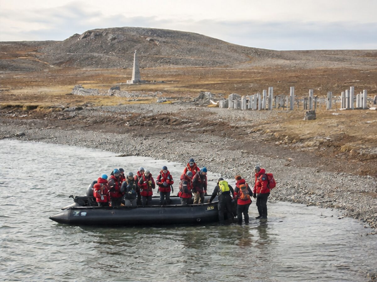Expedition travelers making a Zodiac landing on the barren shore of Beechey Island