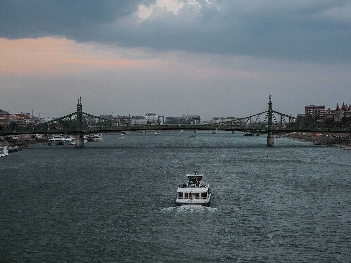 Sightseeing boat traveling on the Danube near Budapest's Liberty Bridge