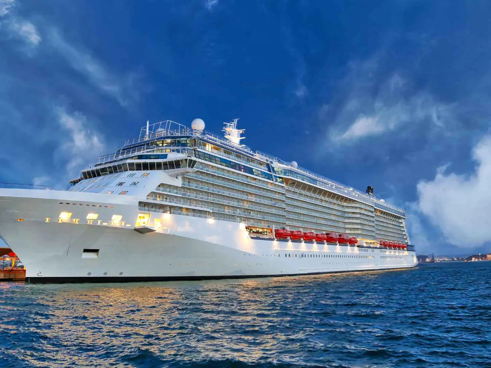 Cruise ship docked in a Japanese harbor beneath dramatic clouds