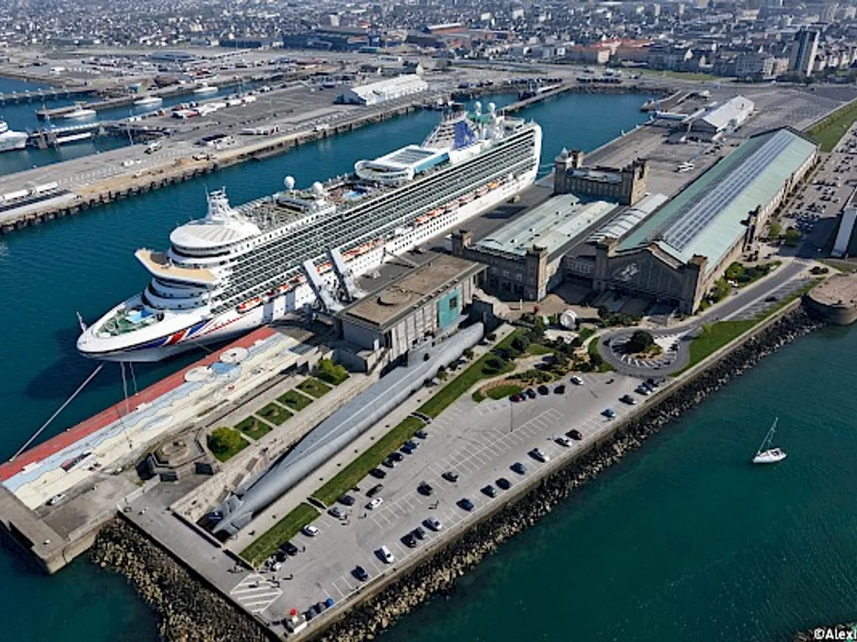 Aerial view of a cruise ship beside Cherbourg's maritime station and port berths