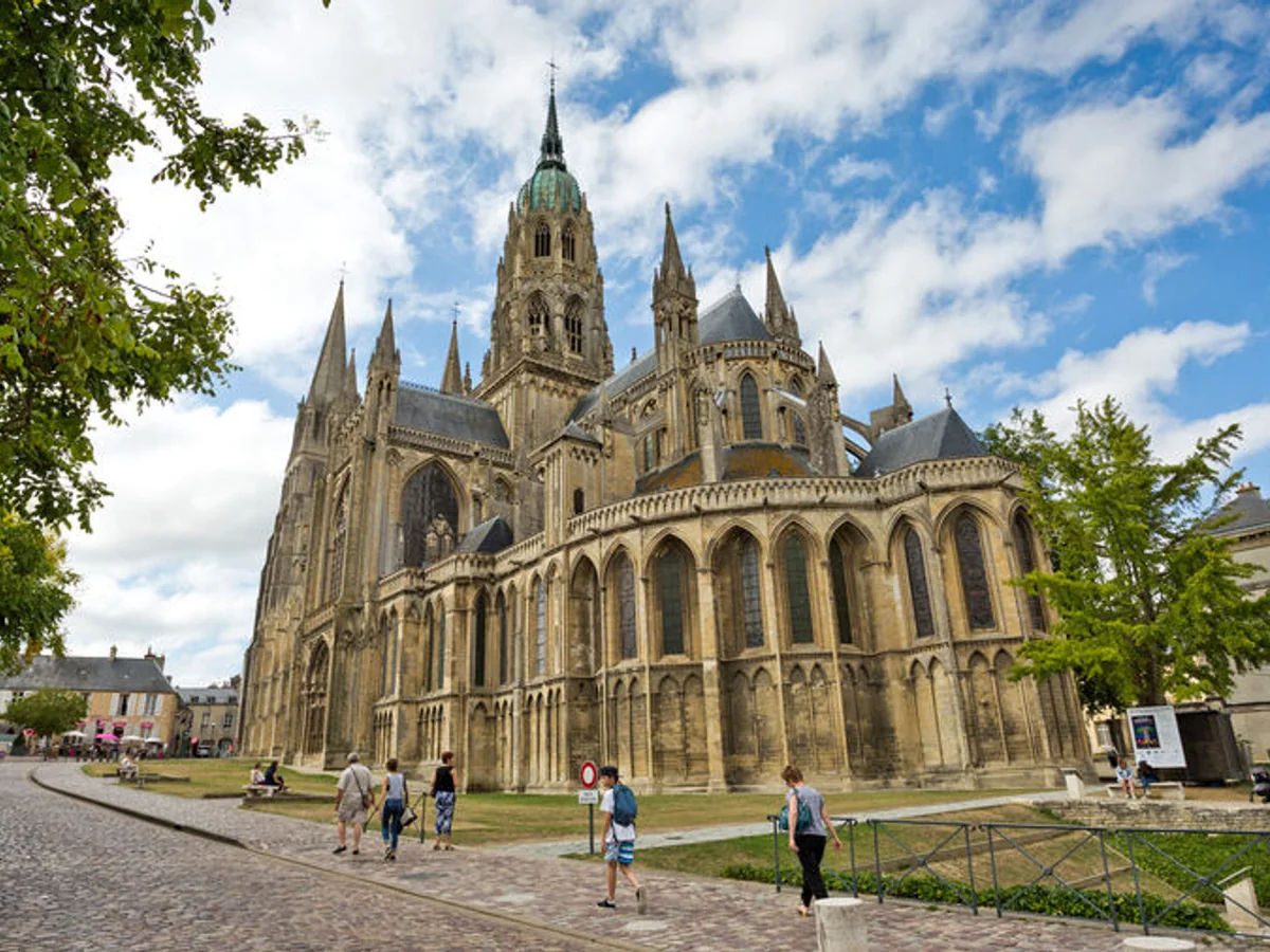 Gothic Bayeux Cathedral beside a cobbled street in Normandy