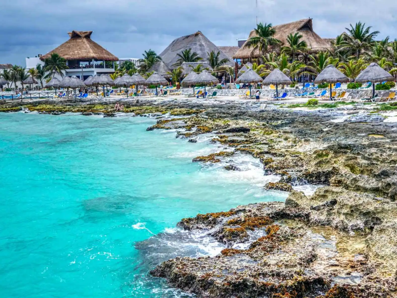 Palapa resort and rocky turquoise shoreline near Progreso