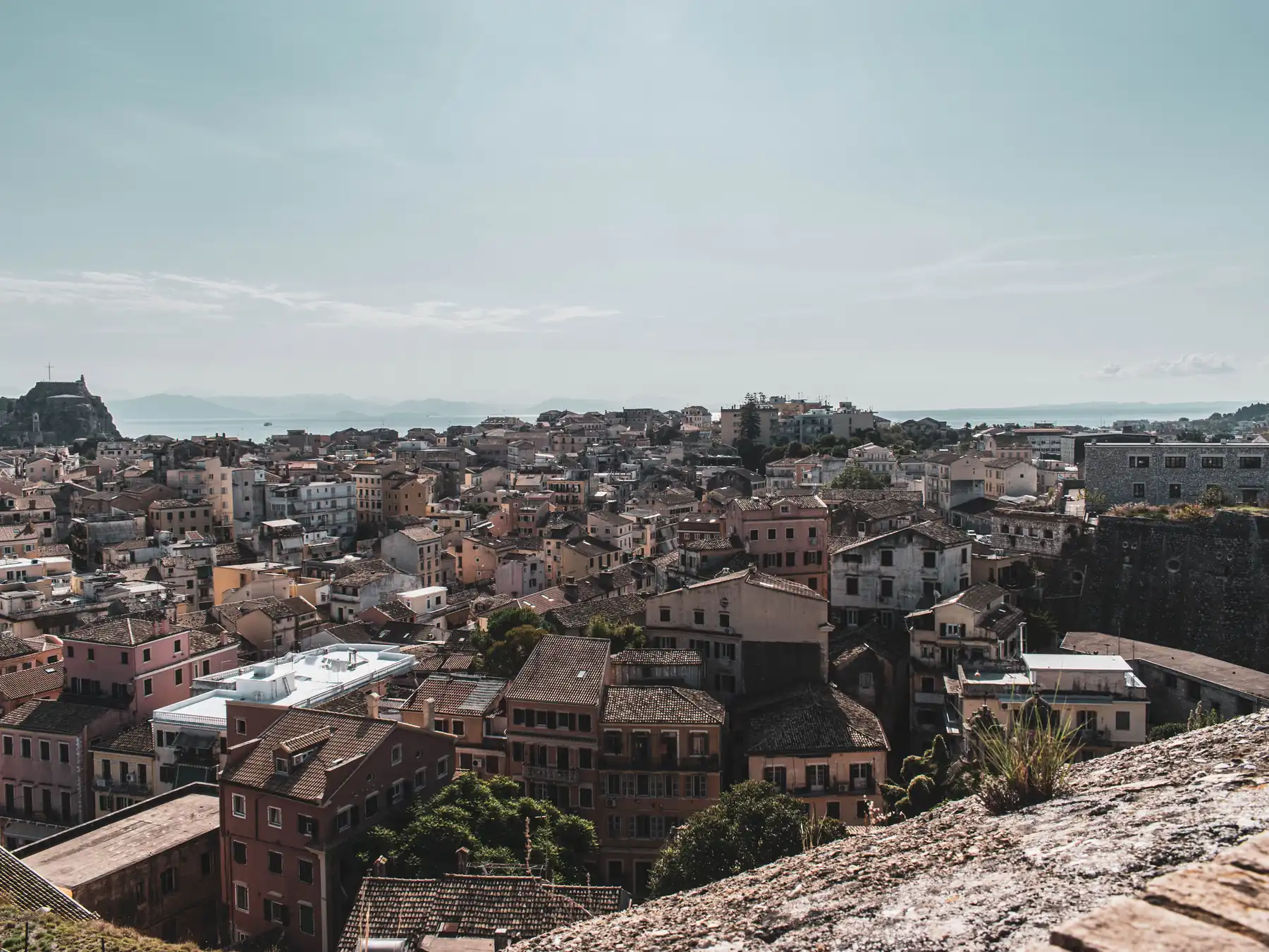 Corfu city rooftops with the Old Fortress in the distance