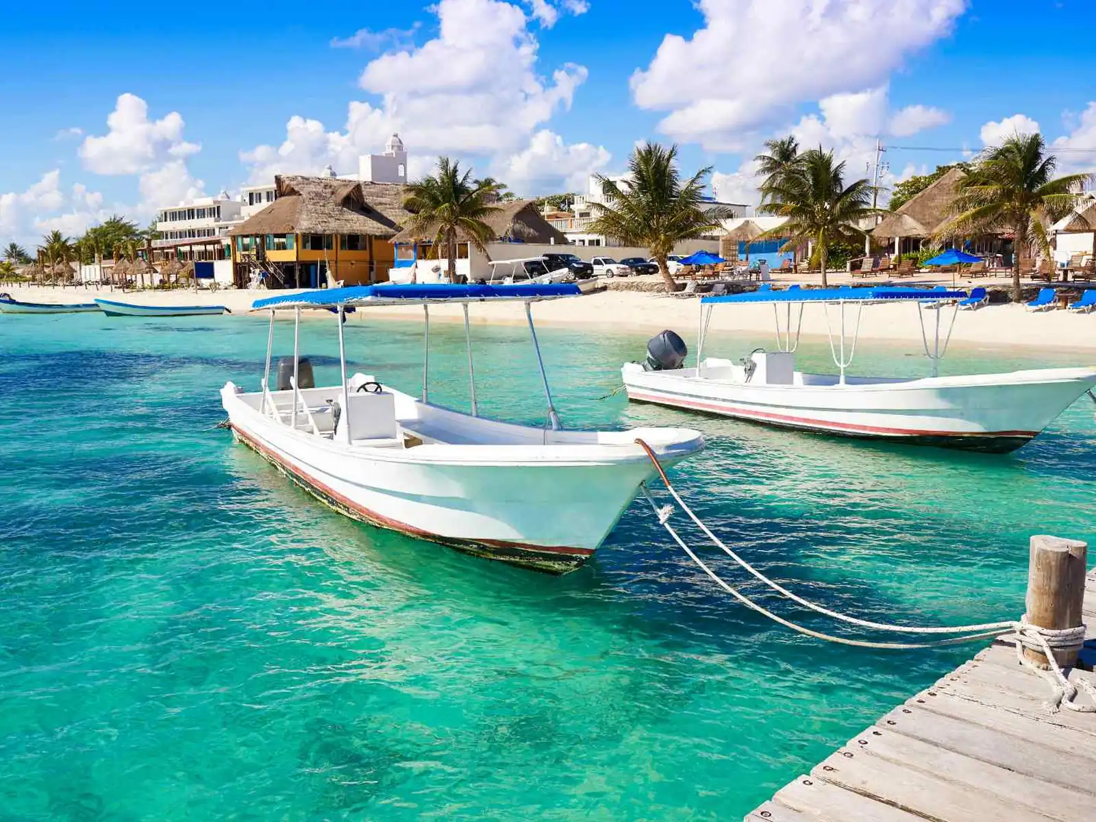 Small tour boats moored in turquoise water at Costa Maya