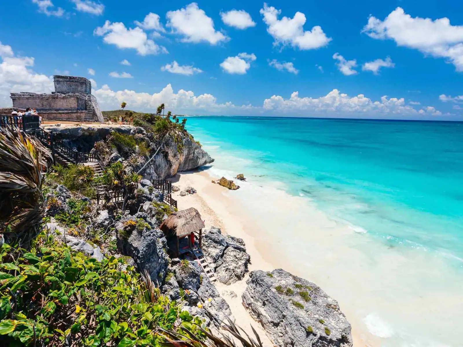 Maya ruins above a white sand beach and turquoise sea at Tulum