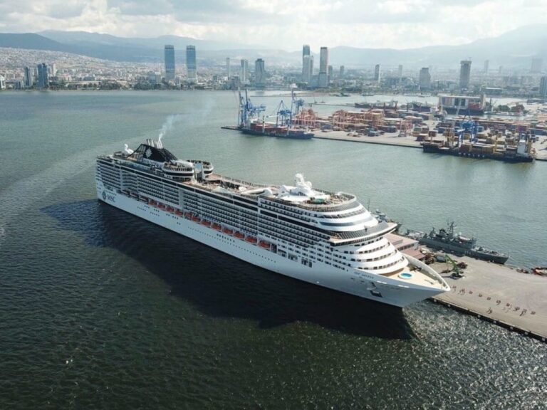 Cruise ship moored at İzmir port with the container terminal and city behind