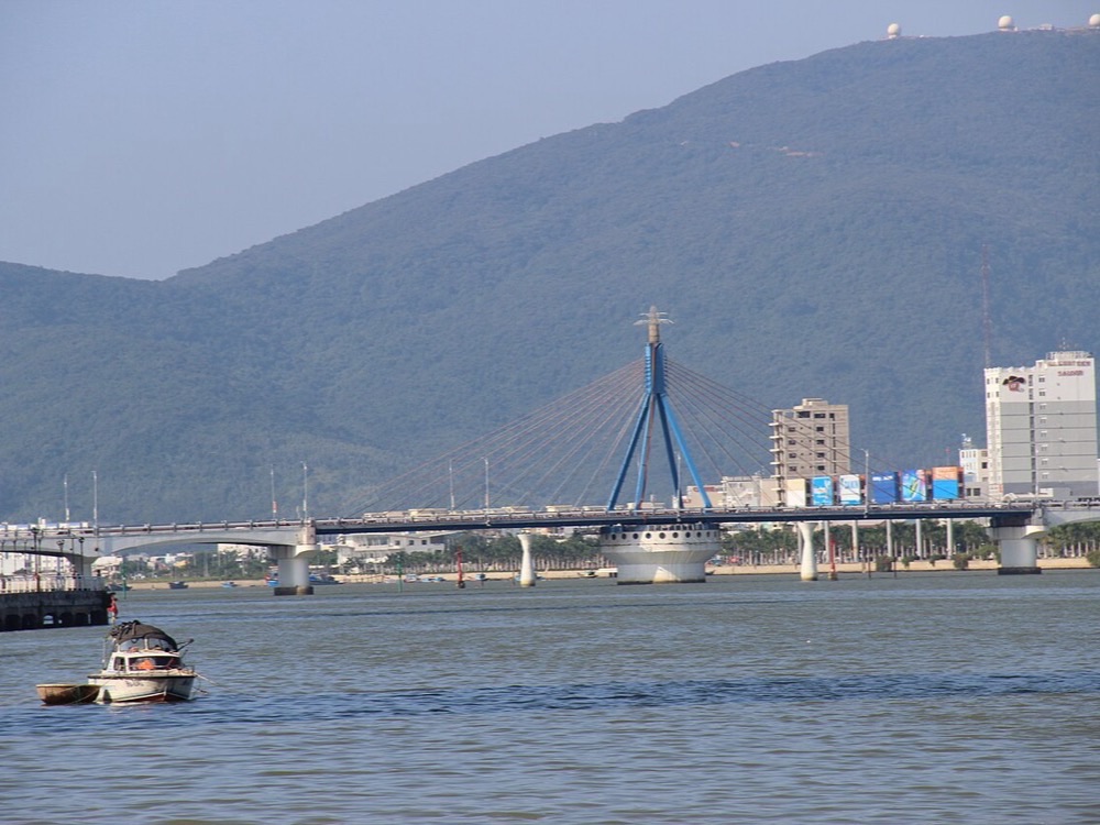Cable-stayed bridge crossing the Han River beneath Da Nang's green hills